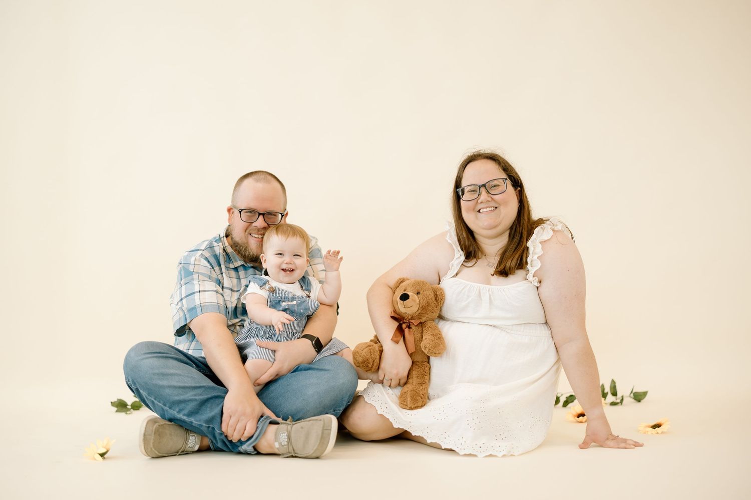 A series of five maternity photos showing a couple with their golden retriever puppy in soft neutral tones.