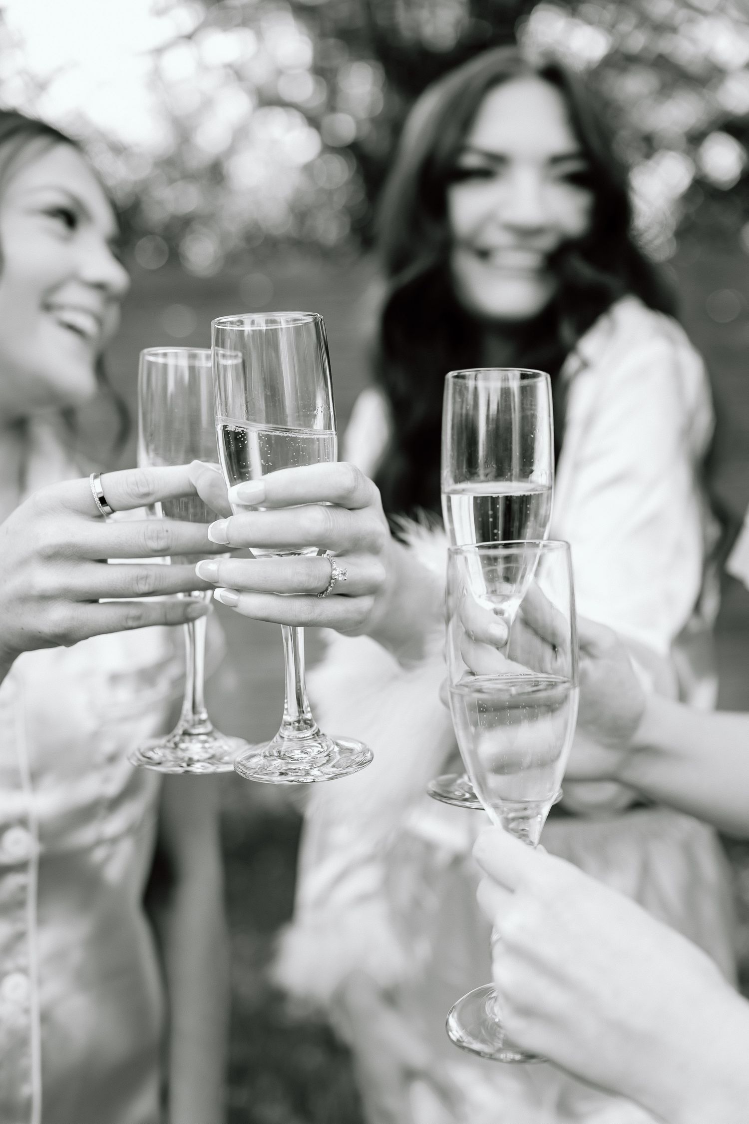 Black and white photo series showing hands toasting with champagne glasses at a celebration.