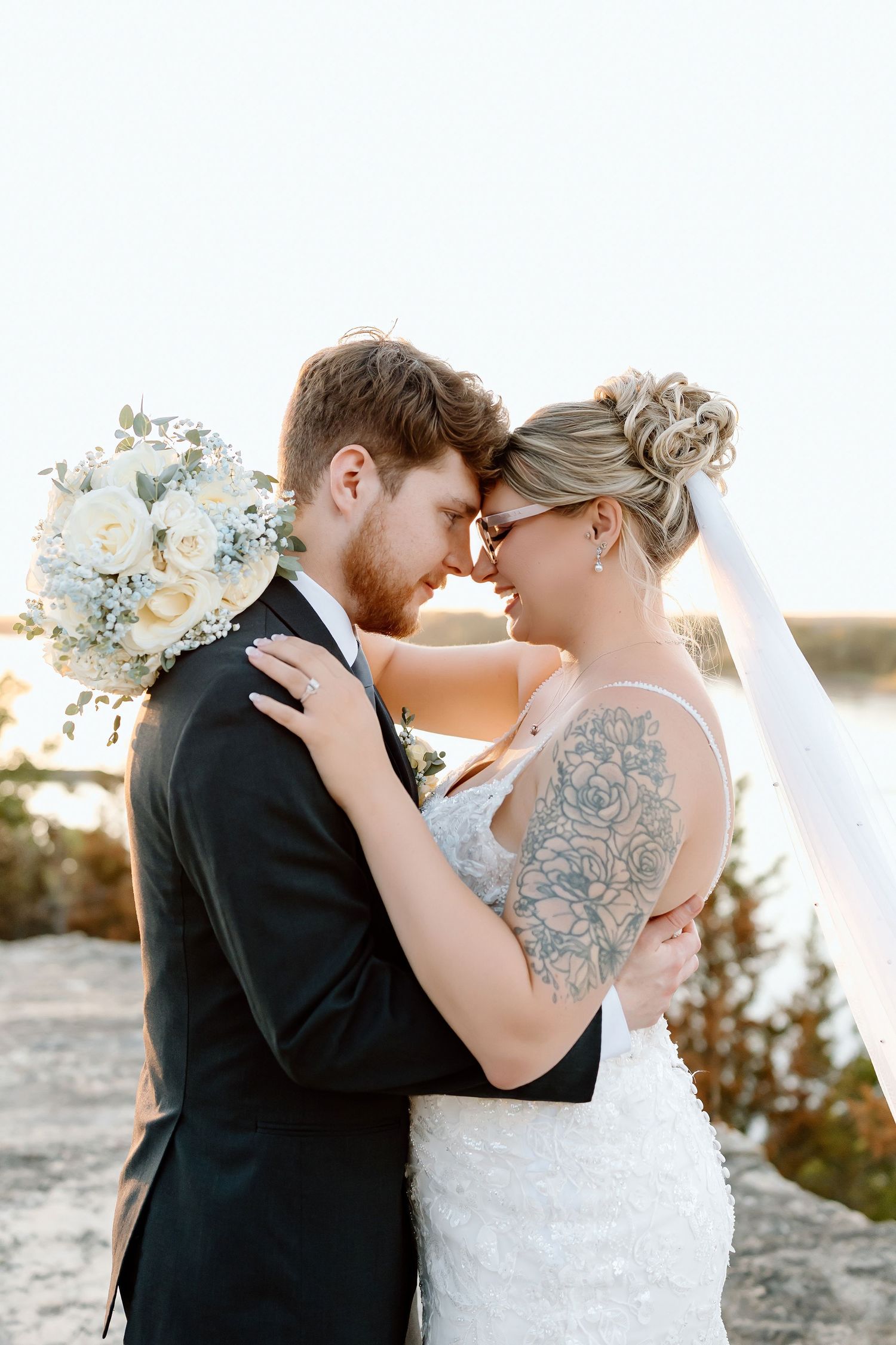 A romantic wedding couple shares intimate kisses in three similar poses against a sunset backdrop.