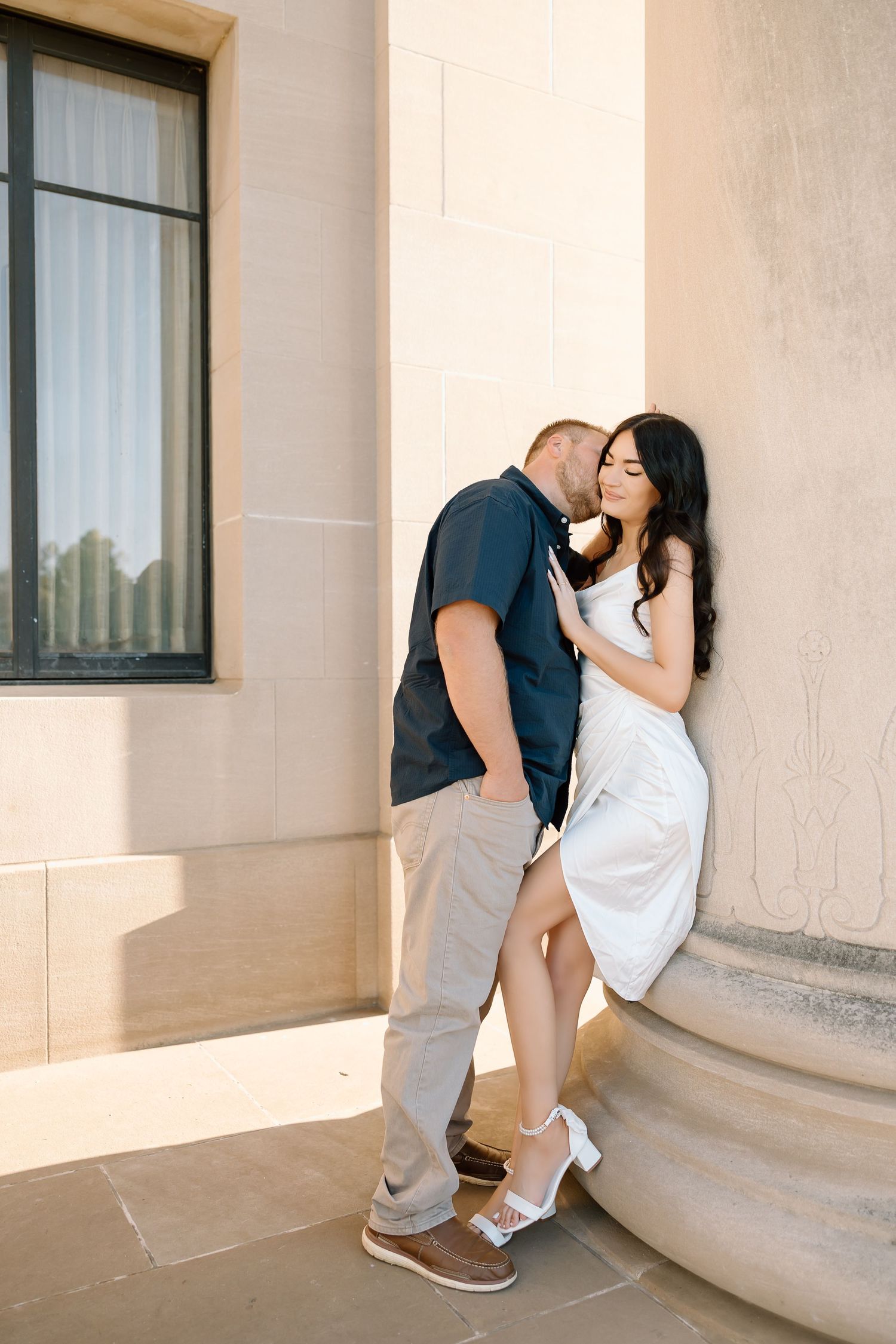 A romantic sequence of four photos showing a couple embracing and kissing on stone steps in warm sunlight.
