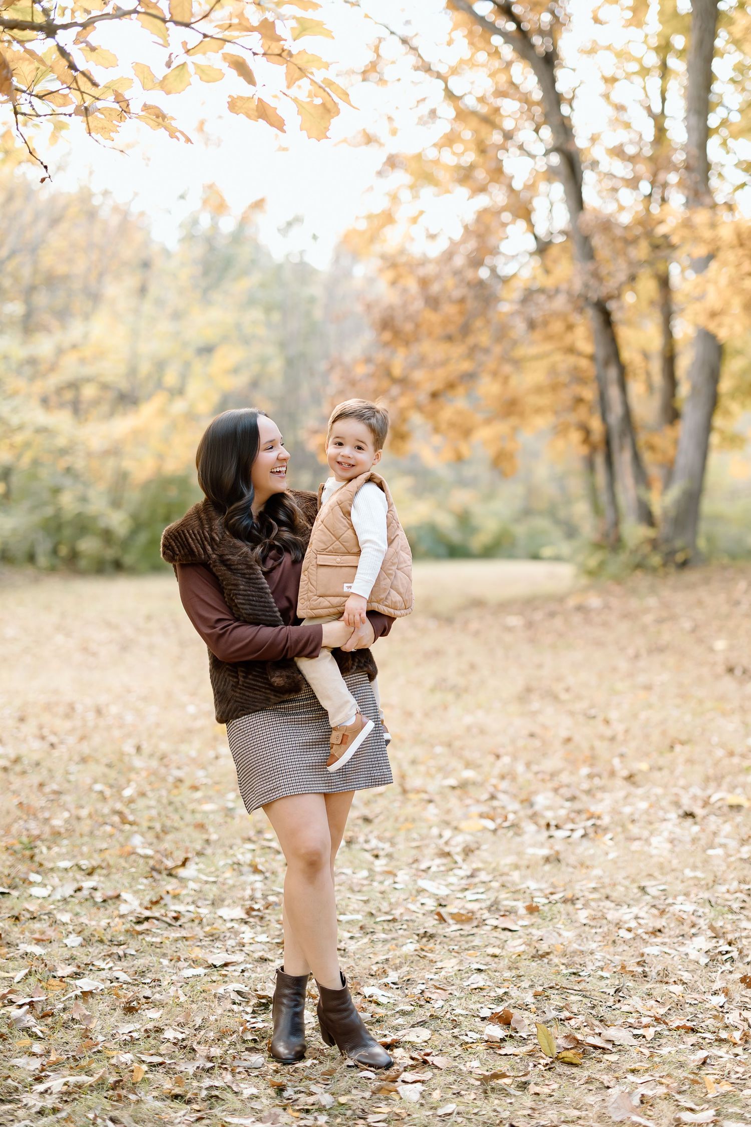 A playful autumn scene in a park with fallen leaves and warm brown tones captured in a series of connected photos.