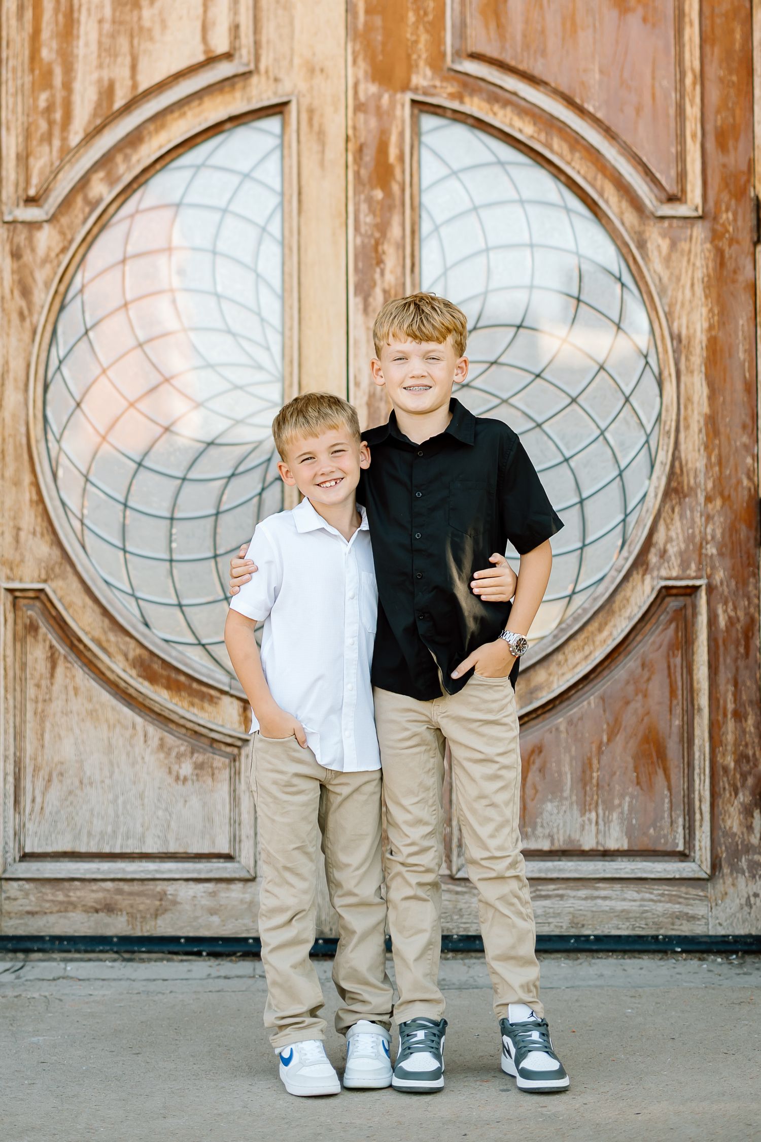 Three connected photos showing children's legs and feet standing against a decorative wooden door with oval glass panels.