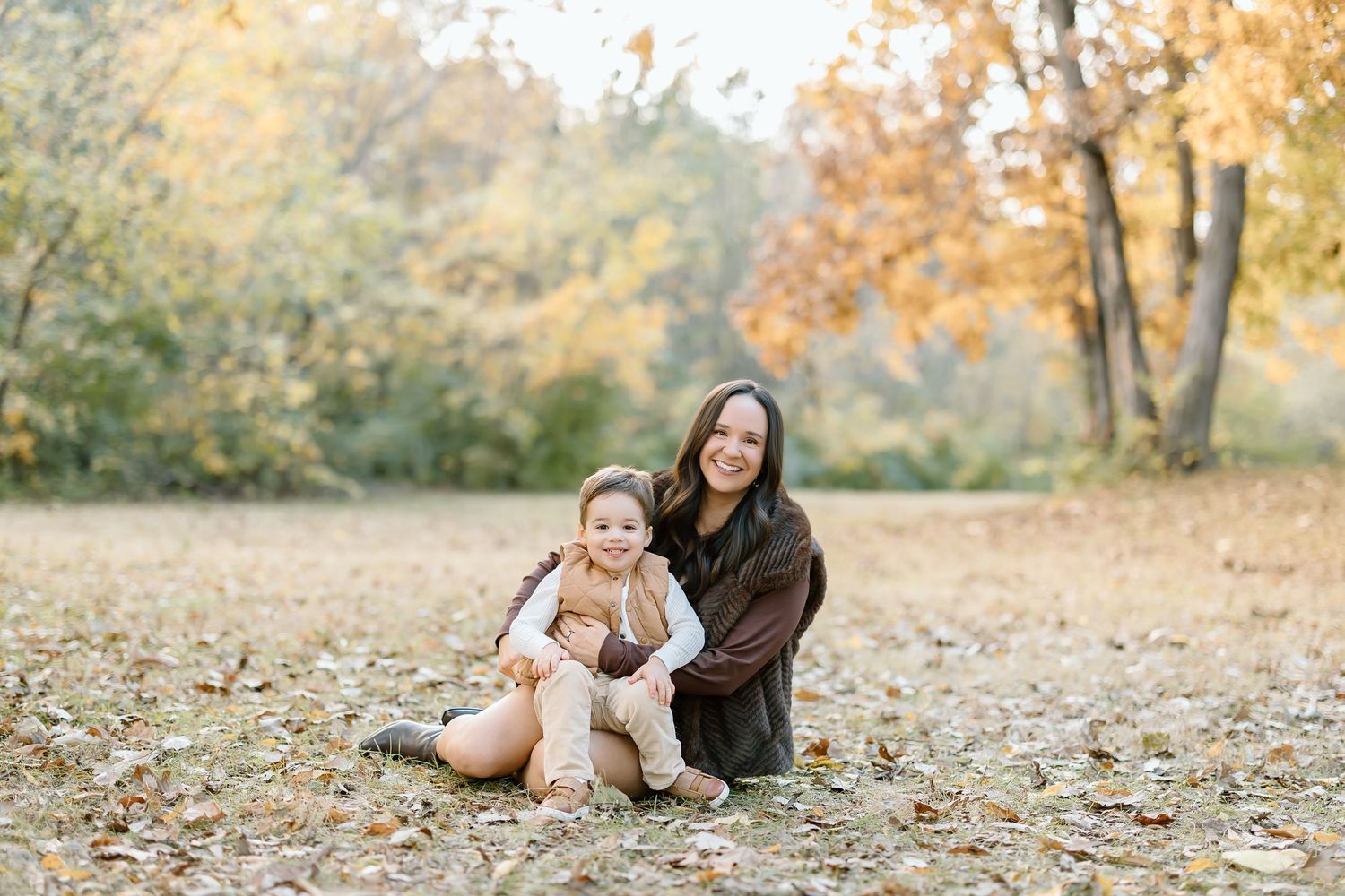 A series of candid autumn family portraits showing tender moments between parent and child in a park setting with golden foliage.
