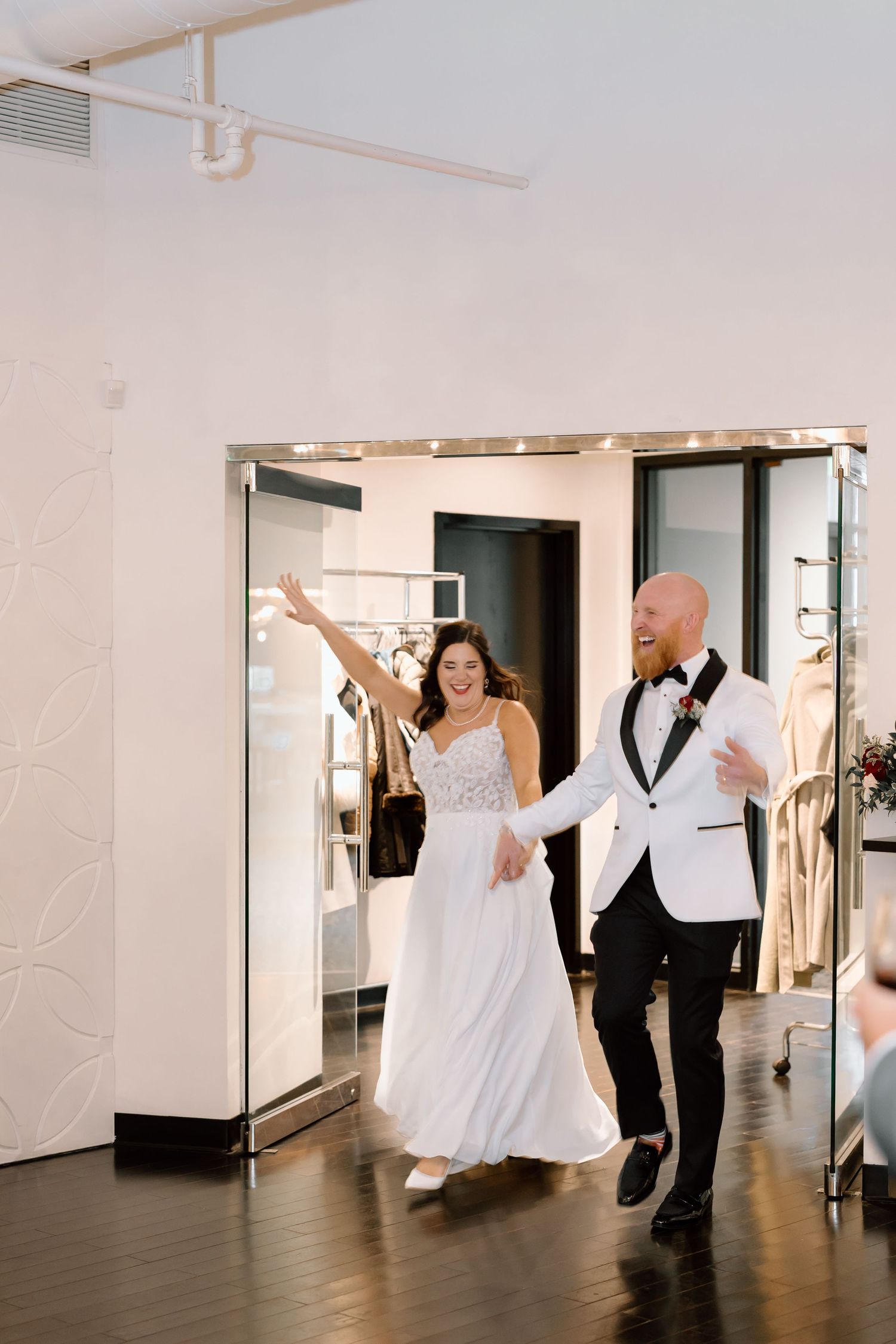 A sequence of four photos showing a couple dancing and twirling in an elegant white dress and tuxedo at their wedding.
