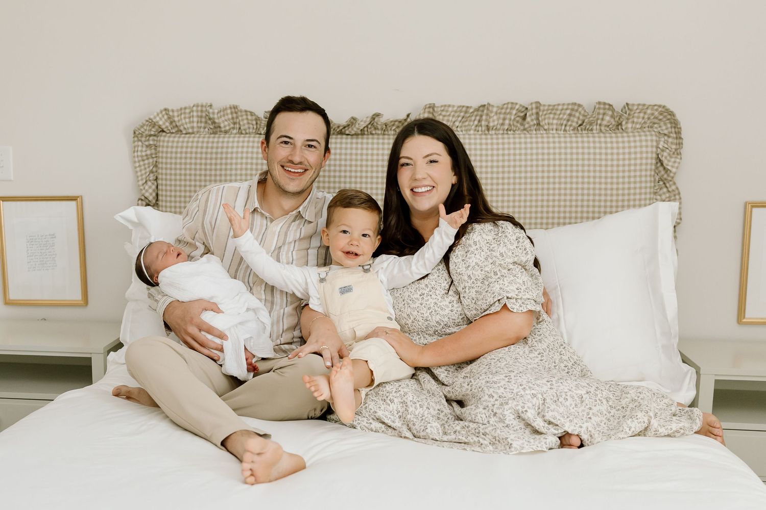 Family members cuddle together in cozy bed wearing matching gray sweaters and white bedding.