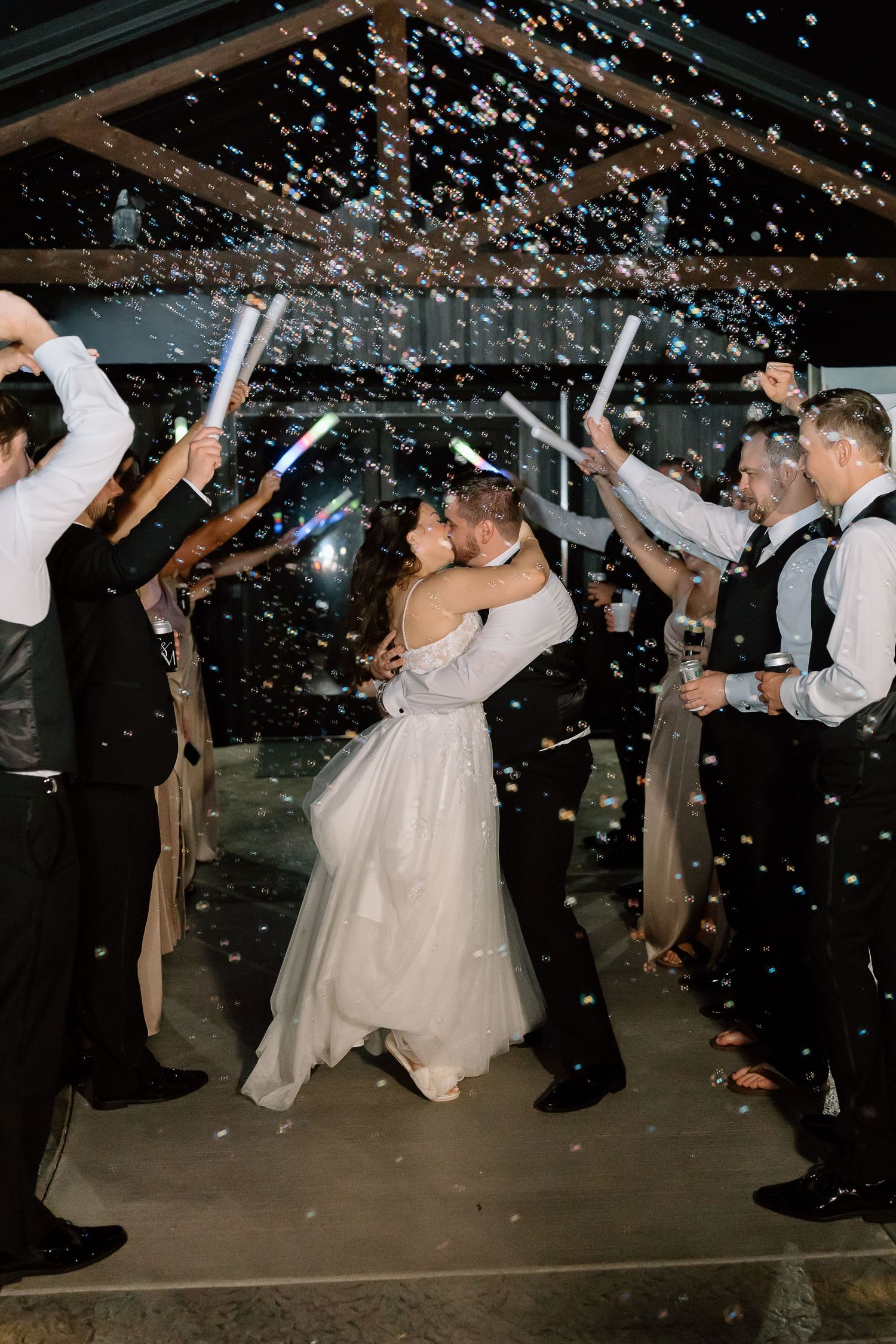 Wedding guests celebrate on the dance floor as confetti falls during a reception party celebration.