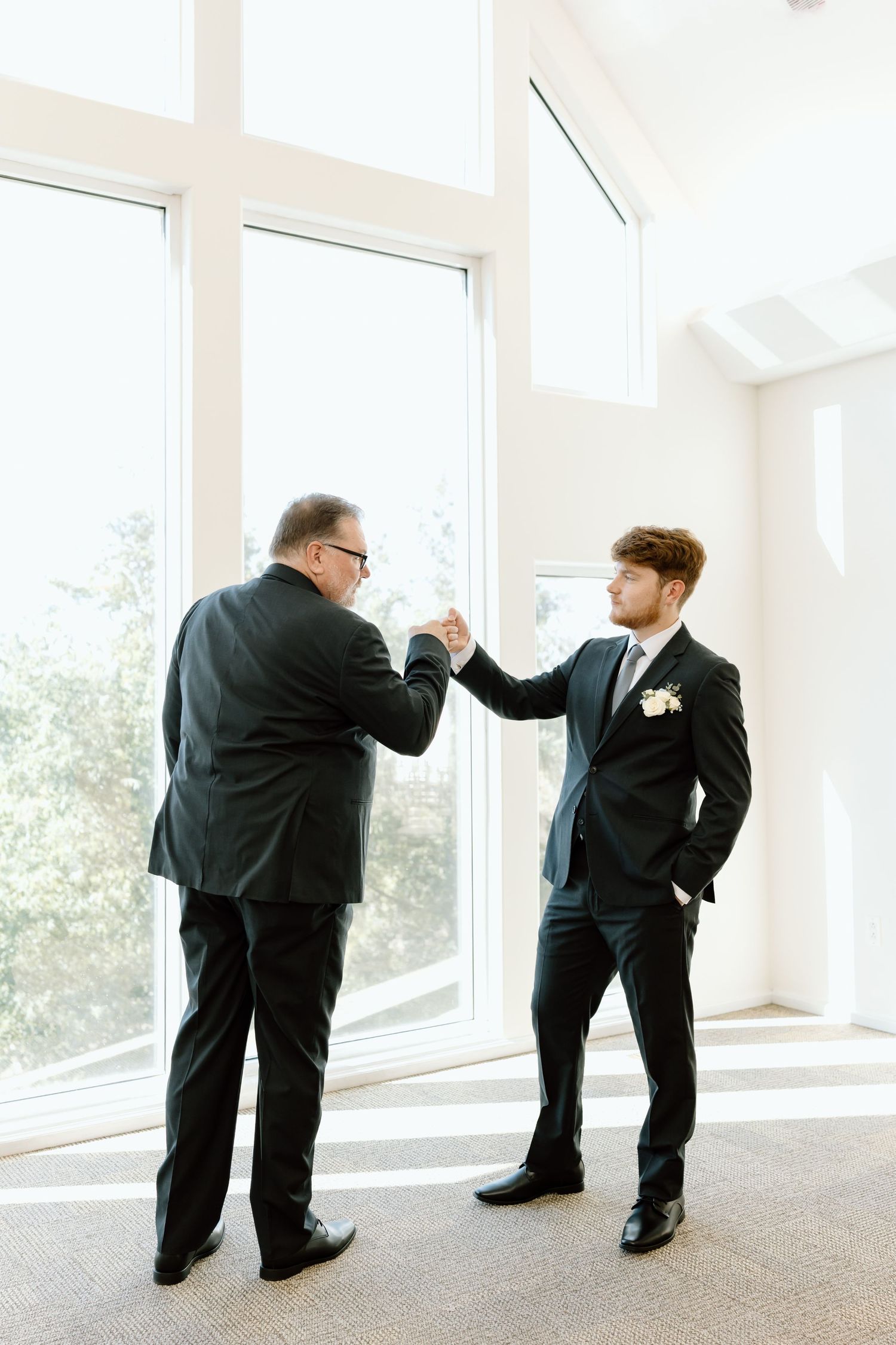 A sequence of four photos showing groomsmen playfully posing by windows in a bright indoor space.