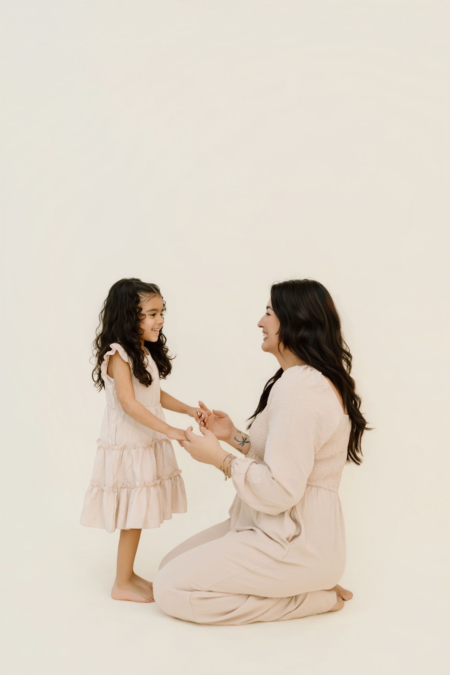 A heartwarming series of photos showing tender moments between parent and child in soft pink and white tones.
