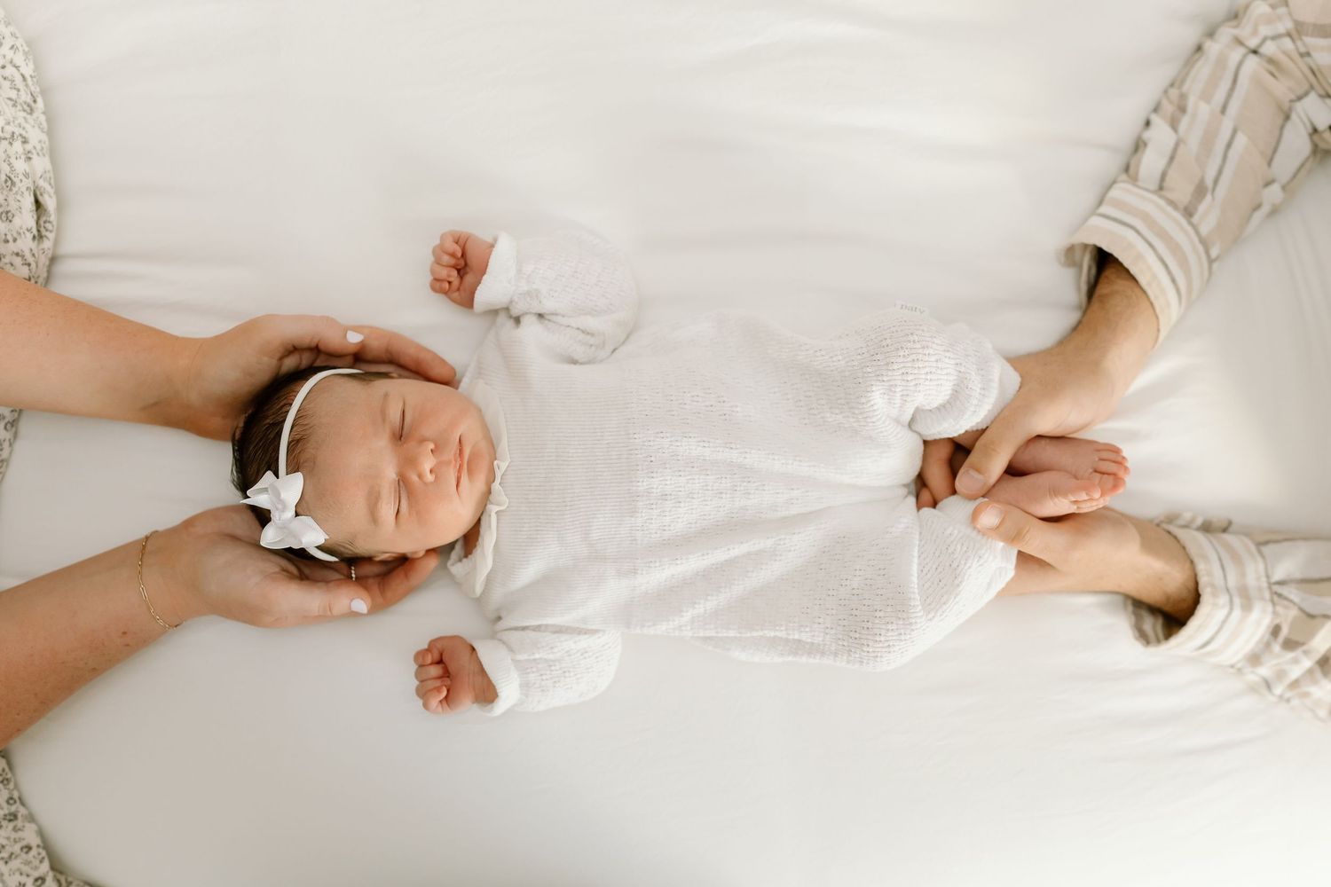 A sequence of photos showing someone lying on white bedding while holding a smartphone in different positions.