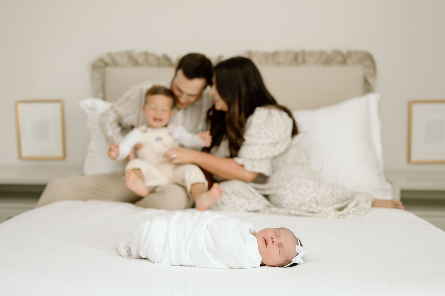 A series of intimate lifestyle photos showing a couple and baby relaxing together on a white bed.