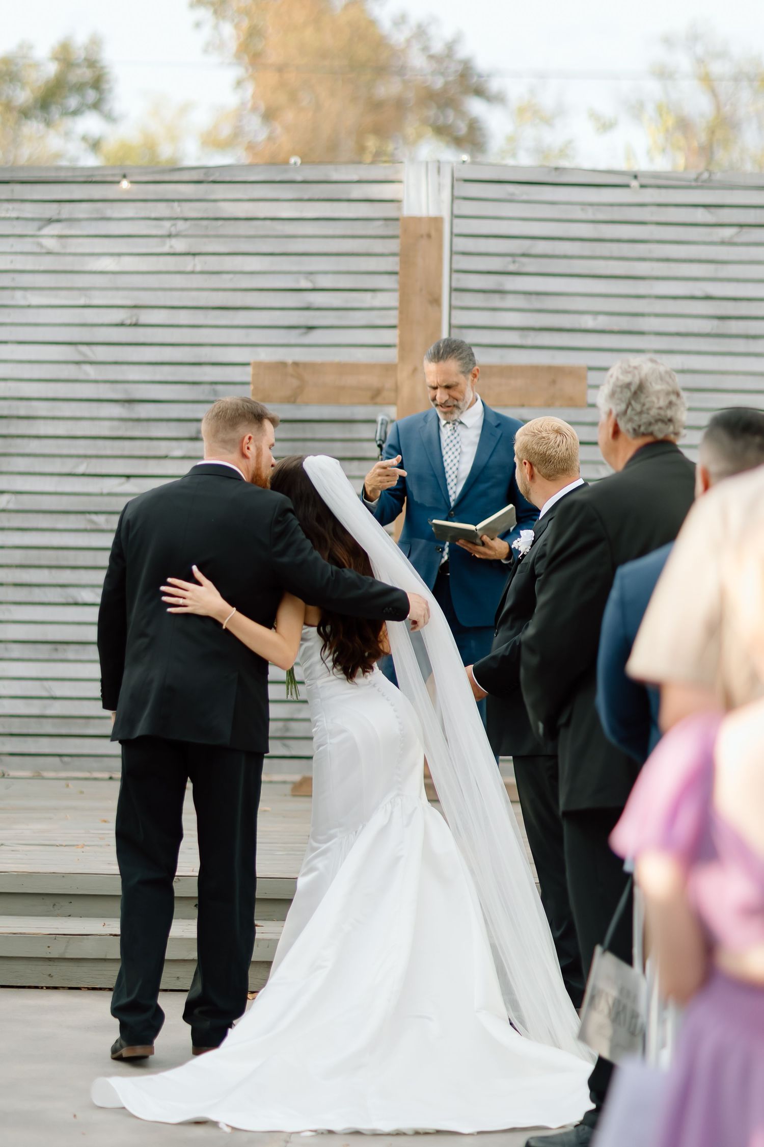 A wedding ceremony sequence shows a couple and officiant at an outdoor venue with horizontal siding in the background.
