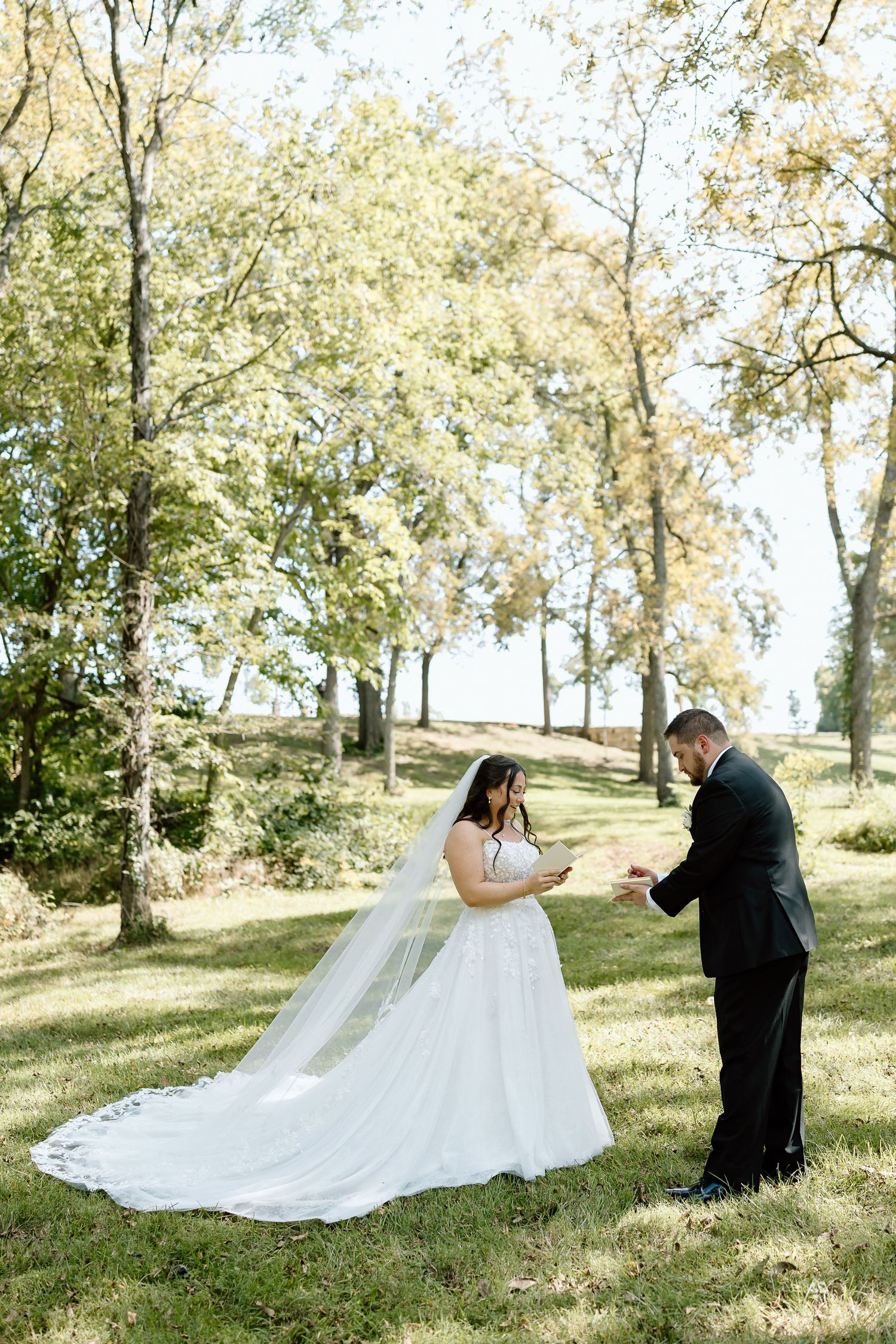 A romantic wedding photoshoot sequence shows a couple in formal attire posing together on a grassy hillside under trees.