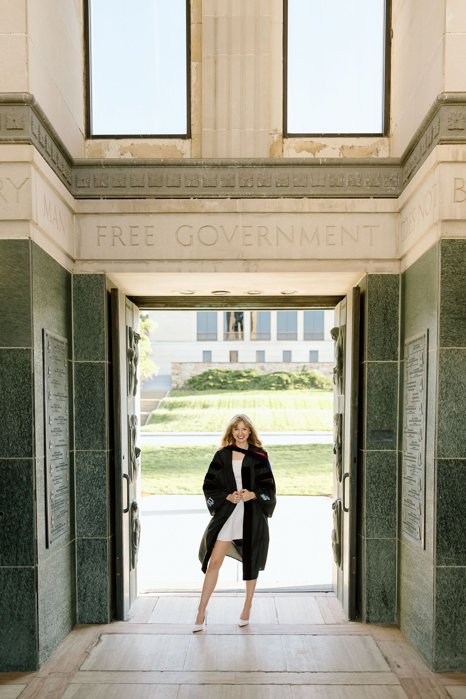 A figure stands in a grand doorway with 'FREE GOVERNMENT' text engraved above at a historic government building.