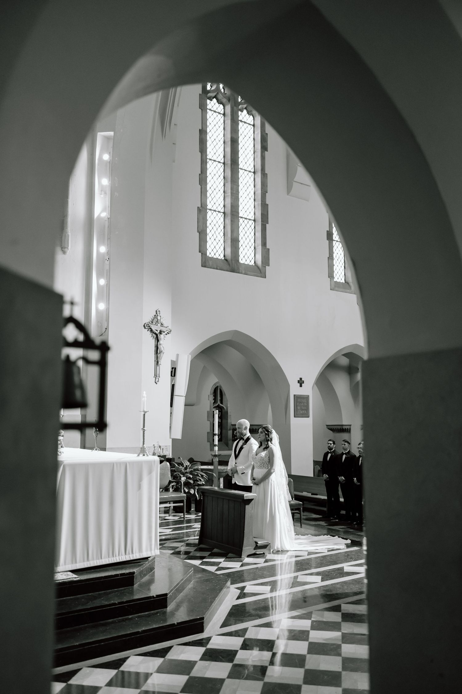 A series of black and white photos showing a church interior with checkered floors and arched doorways in dramatic lighting.