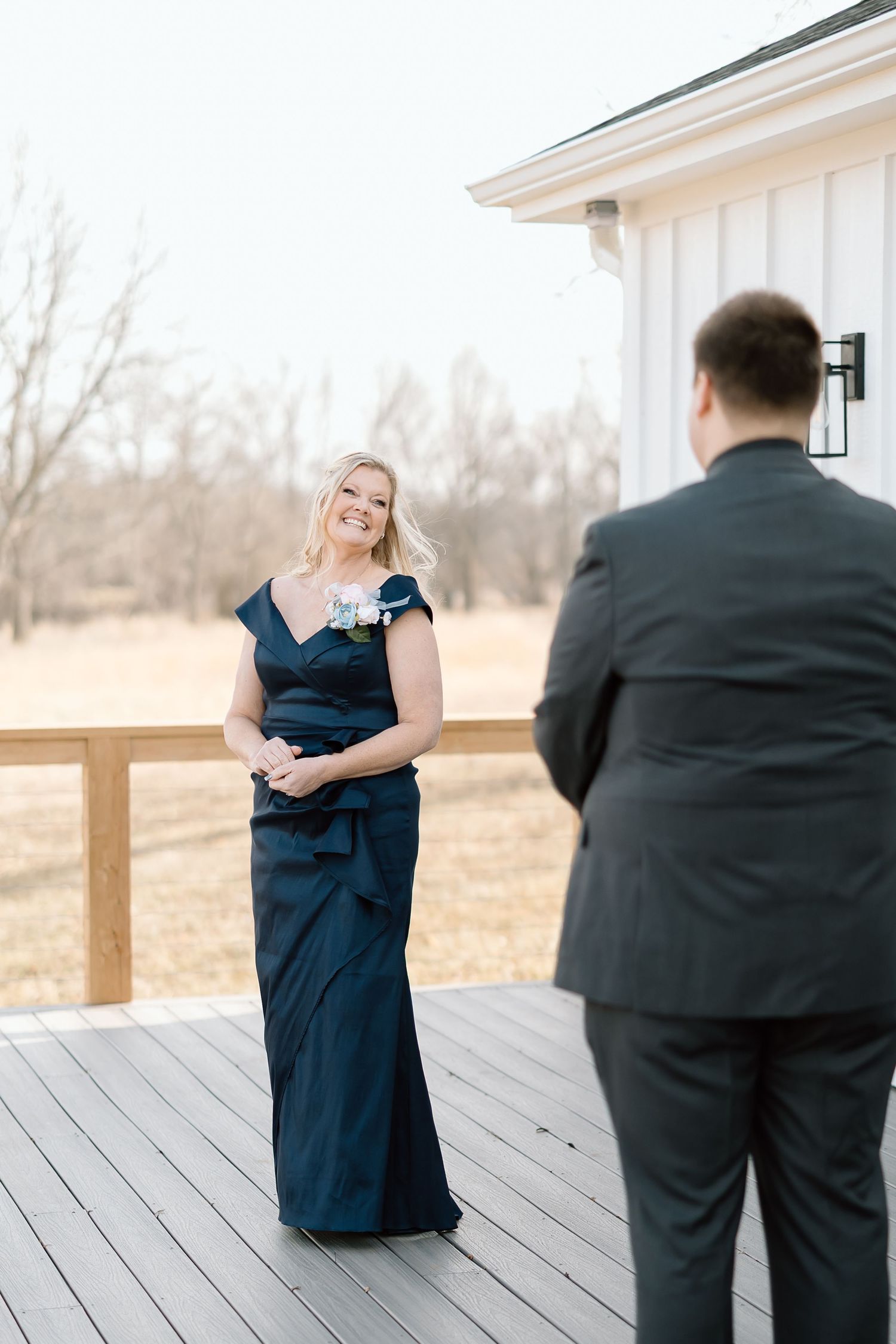 A first look sequence showing a couple's emotional reaction during their wedding day on a wooden deck.