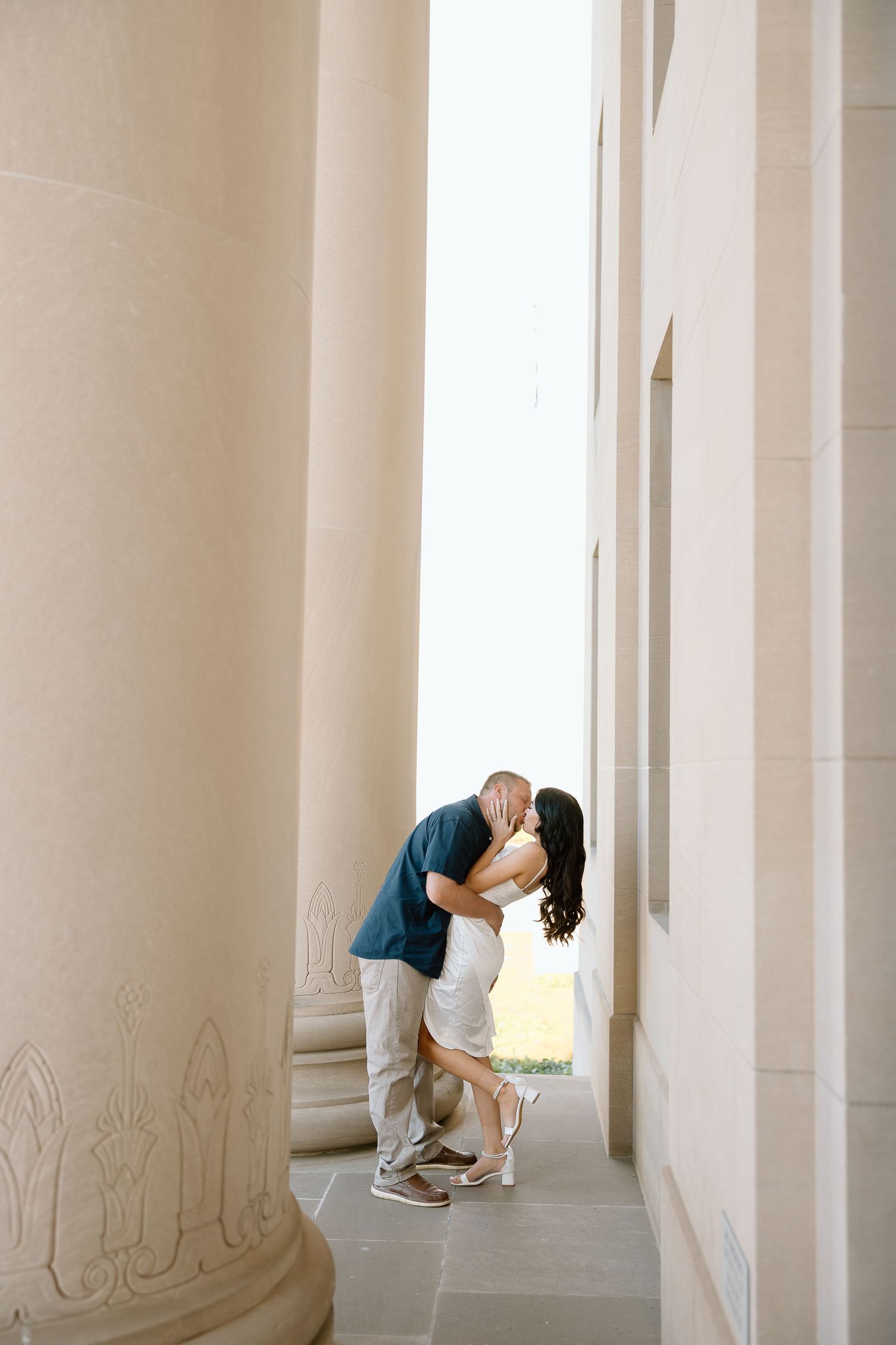 A triptych photo shows someone bending down to examine or write on a wall in a bright white columned hallway.