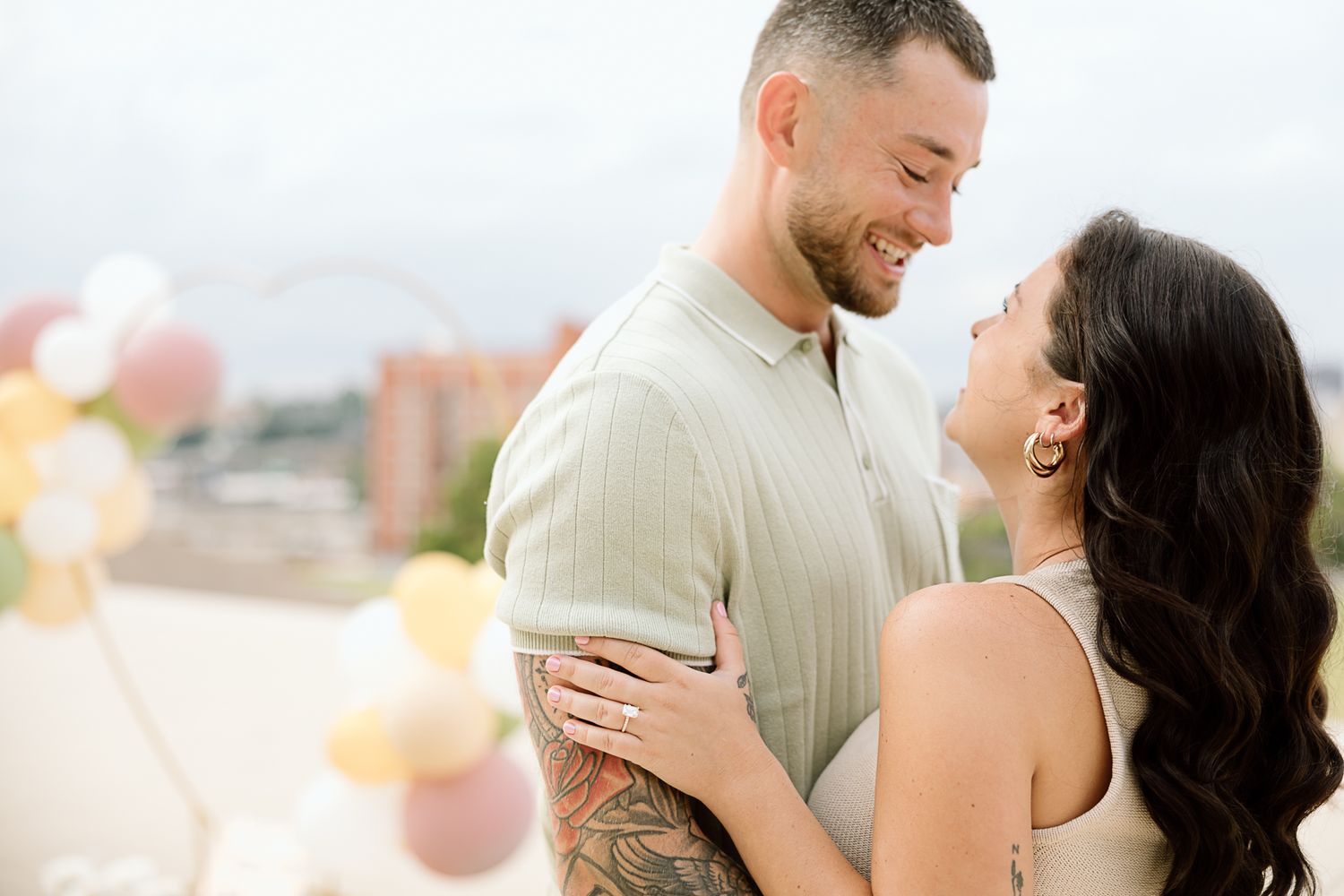 Happy couple shares intimate moments while posing together in a light-filled setting.