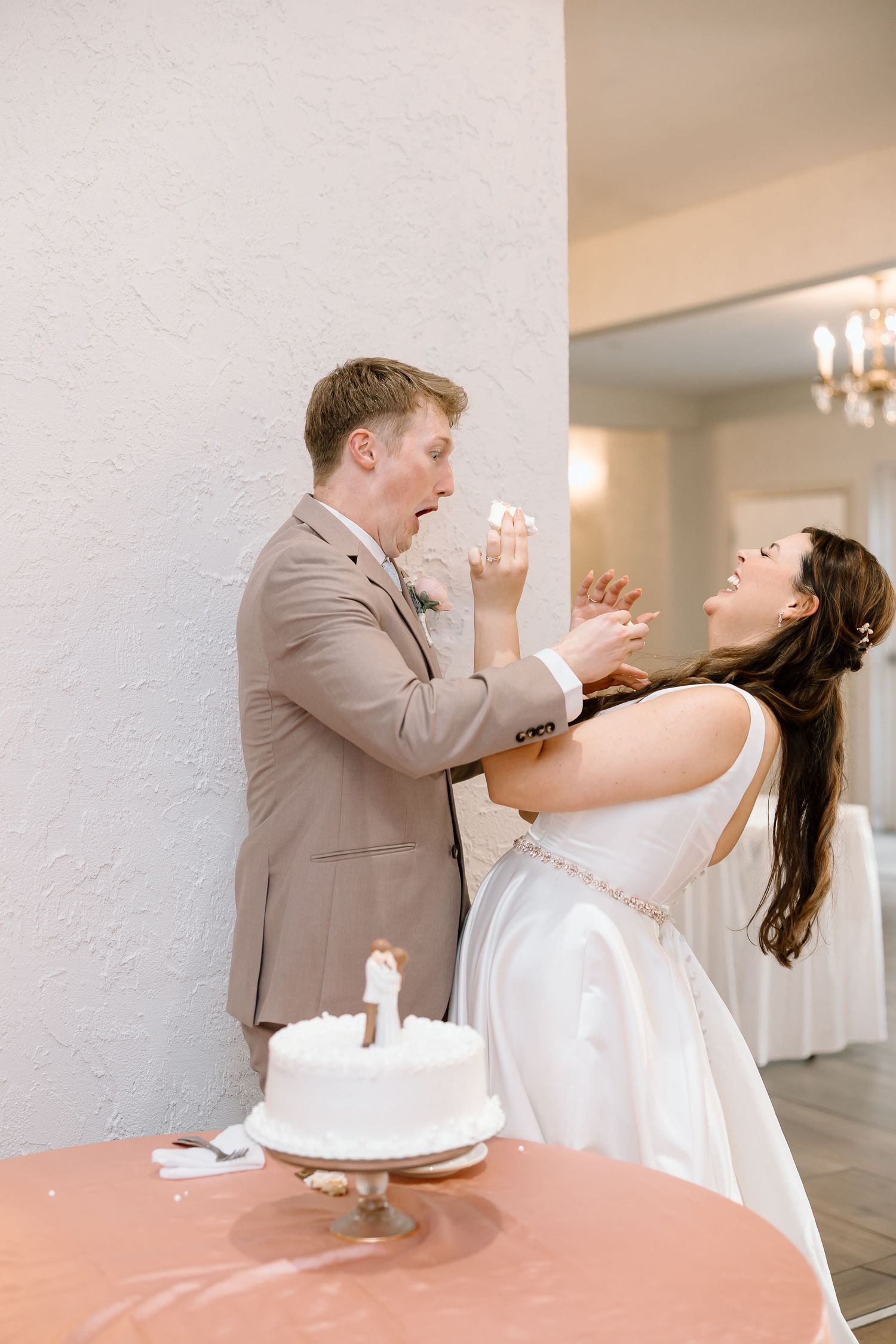 A playful sequence of wedding photos showing a couple sharing cake at their reception in a light-filled room.