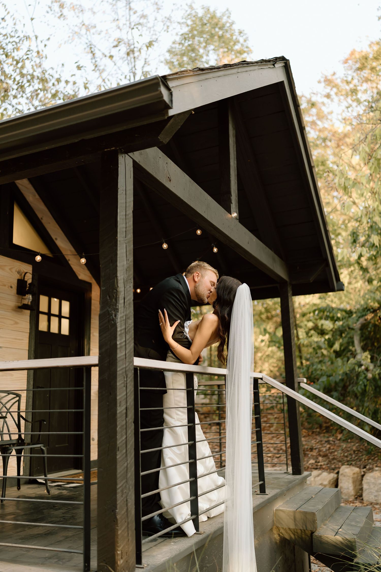 A series of five connected photos showing a couple embracing on a rustic wooden porch with white posts at sunset.