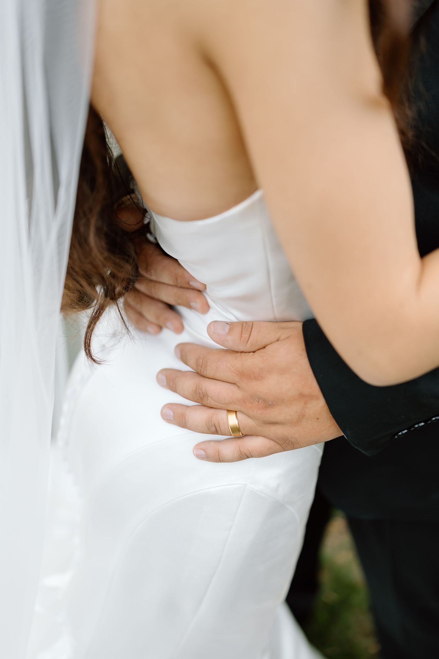 A series of wedding photos showing hands embracing in formal attire with a white dress and ring detail.
