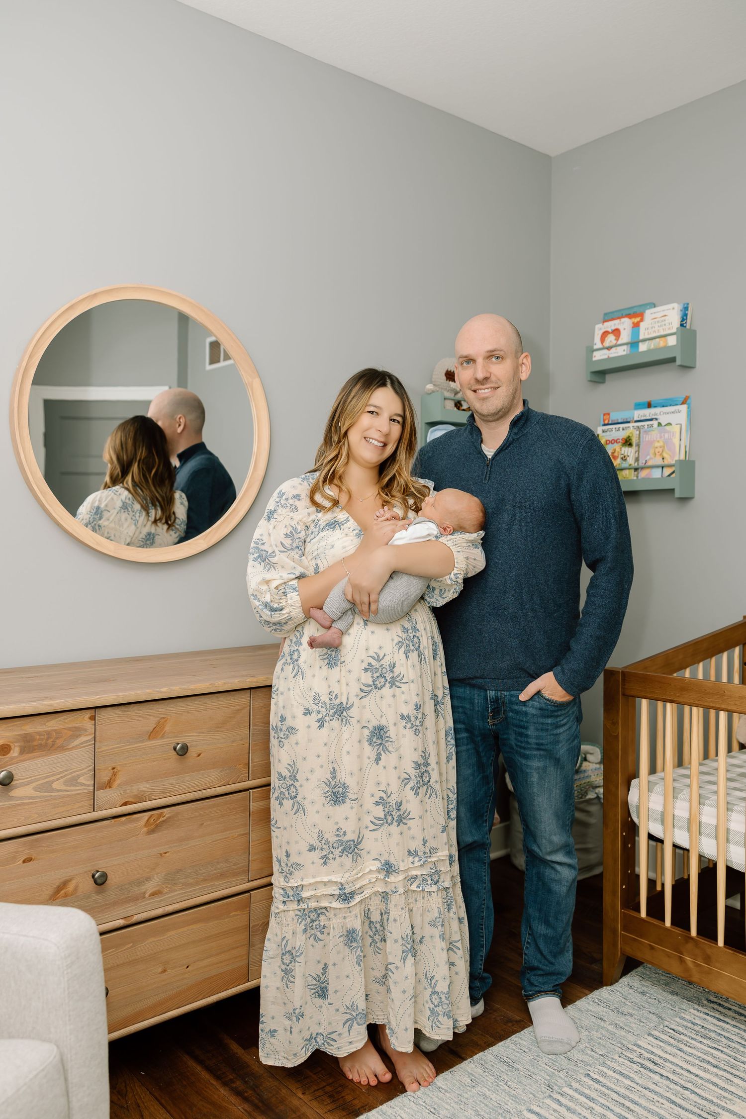 A nursery room decorated with round mirrors and wooden furniture shows tender family moments in a series of photos.