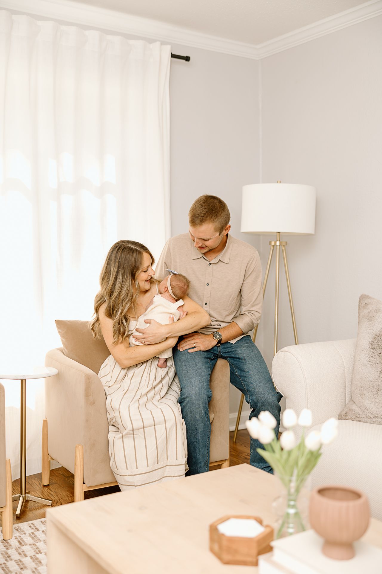Family sharing intimate moment together in minimalist living room with modern furnishings.