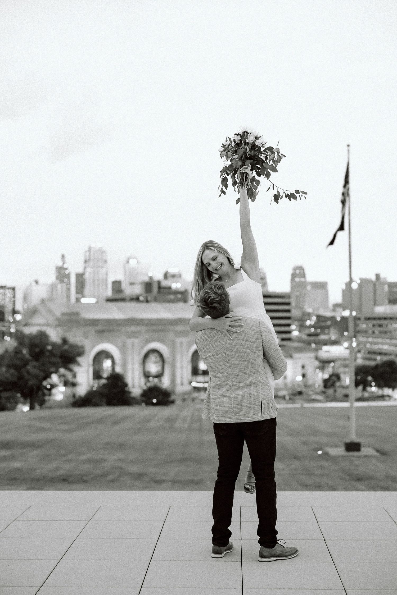 A sequence of black and white photos showing a person standing on a hill against an urban skyline.