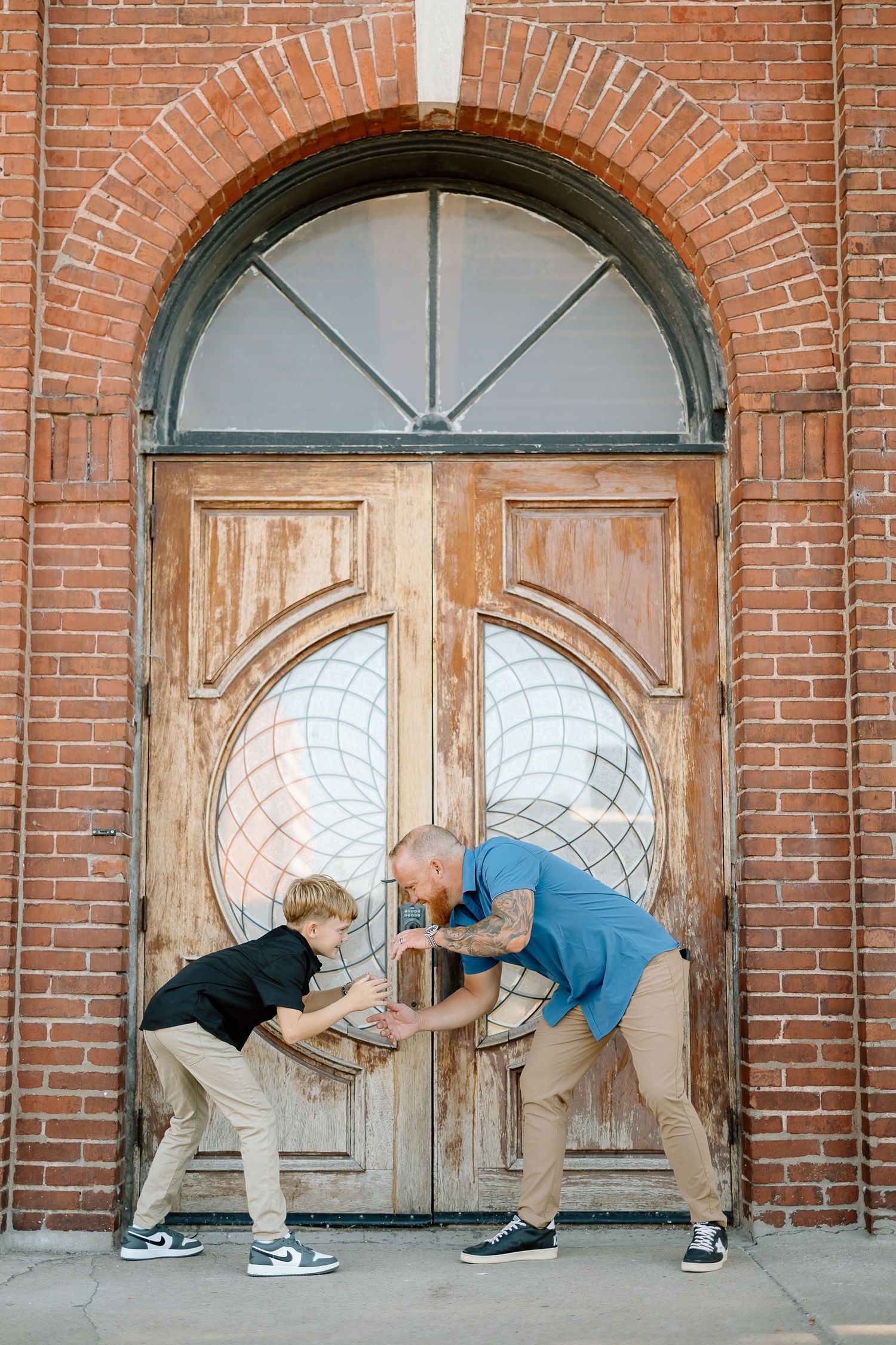Three sequential photos show someone bending down to look through holes in a wooden door against a red brick building.
