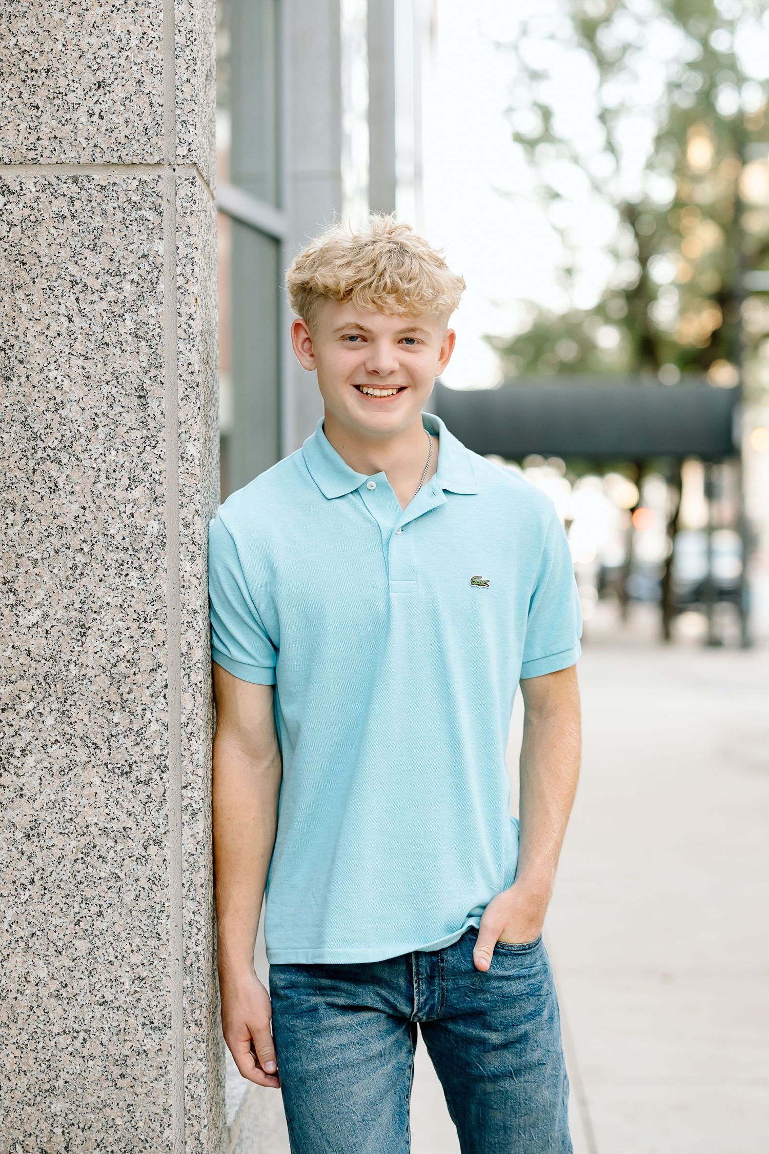 A series of casual outdoor portraits showing someone wearing a light blue polo shirt and jeans against a textured wall.