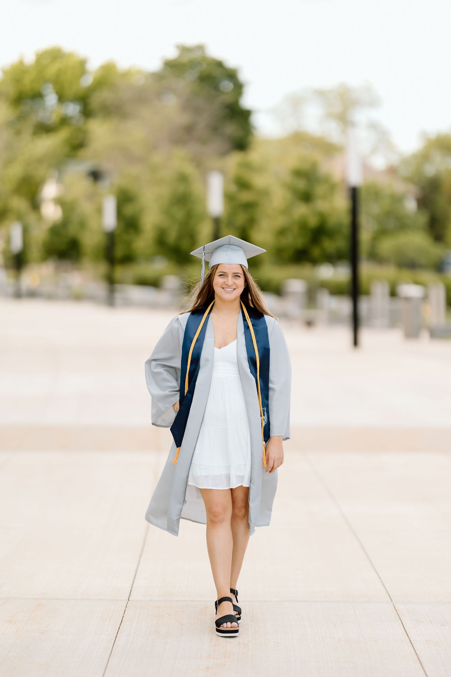 A series of four candid walking shots showing someone in casual summer attire with a backpack on a sunny day.