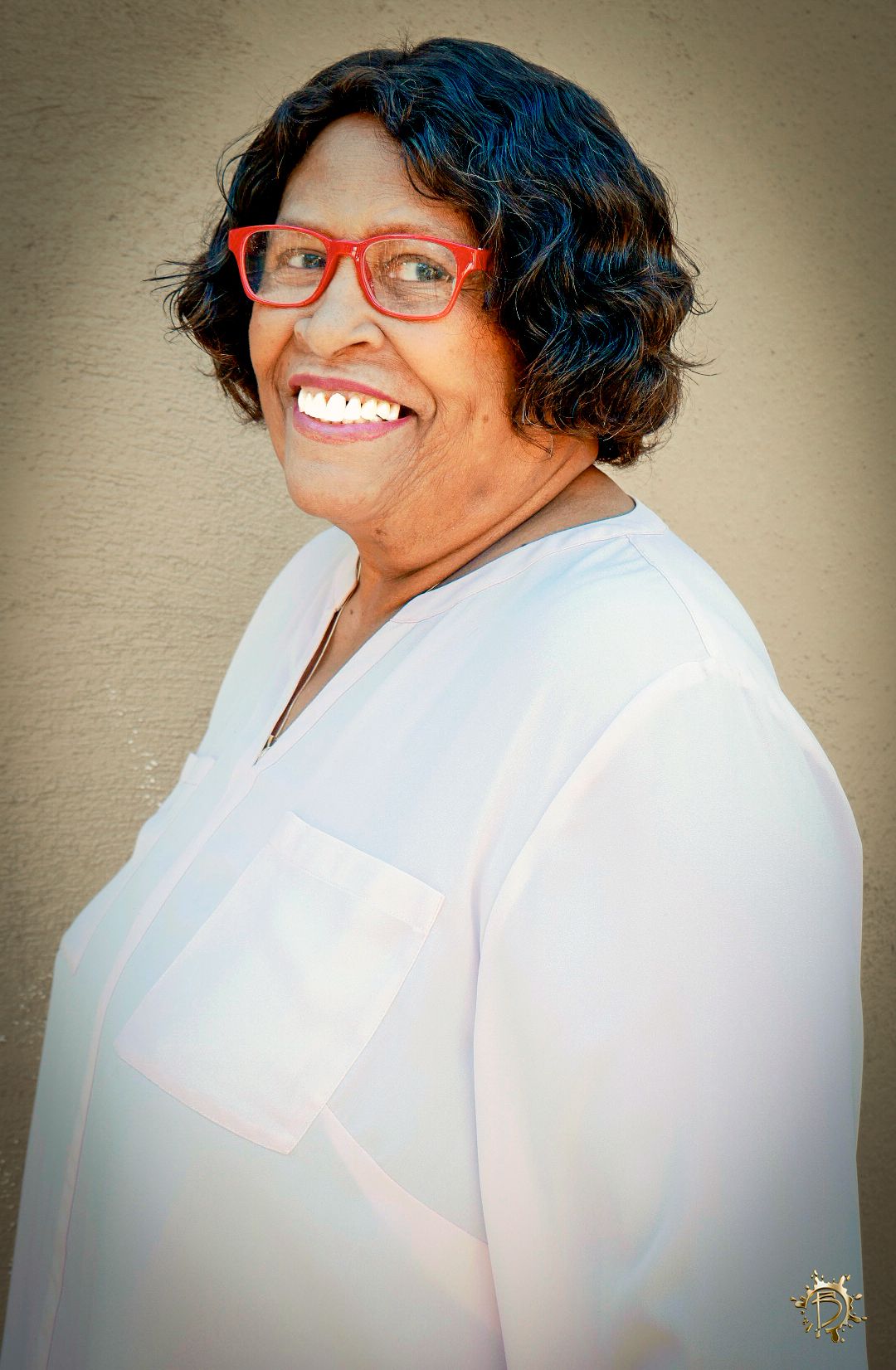 My beautiful grandmother in a white blouse & red glasses. She smiles as I take one of many headshots for her updated portfolio