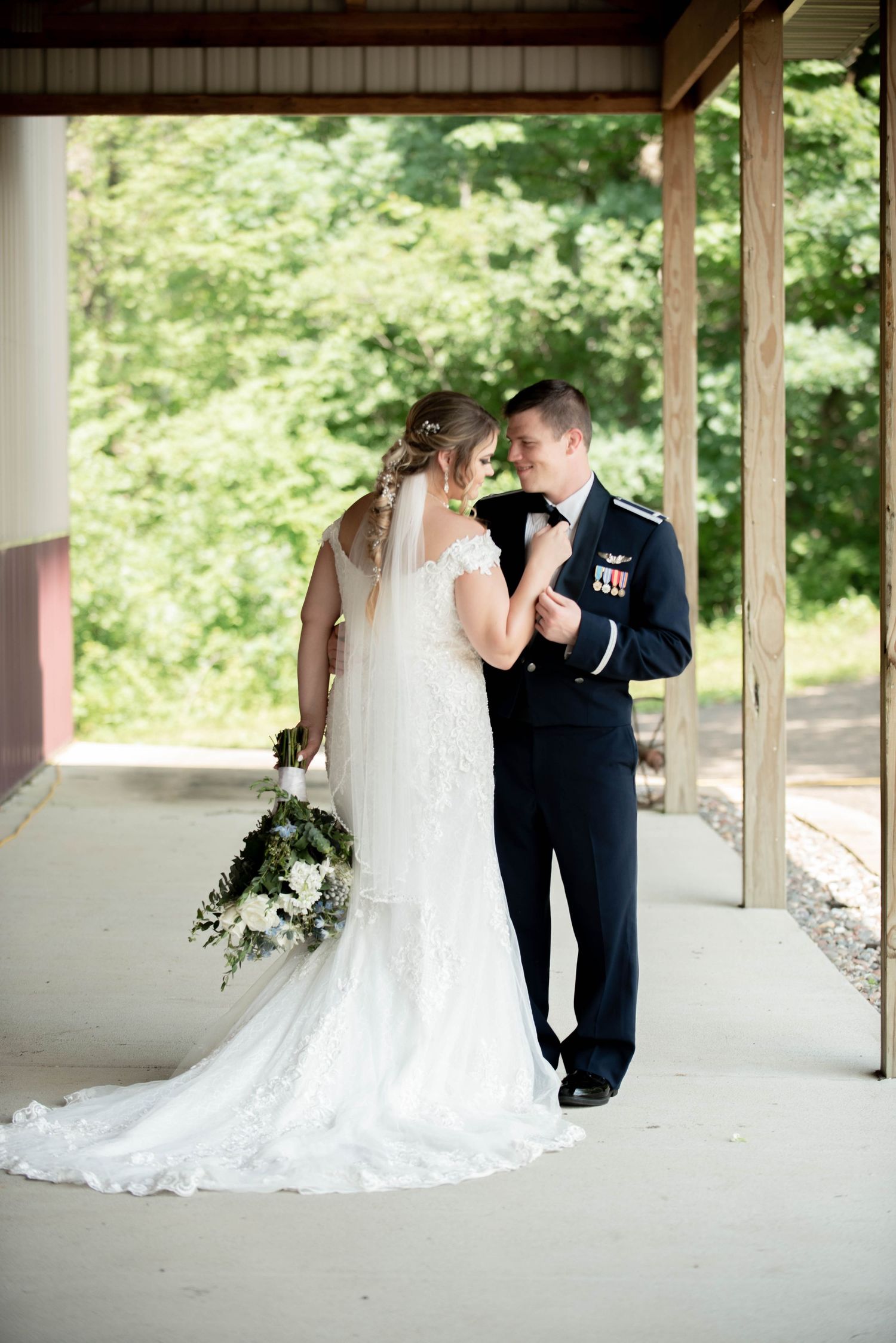 Intimate moments between wedding couple under a covered wooden walkway. Zimmerman MN Weddings