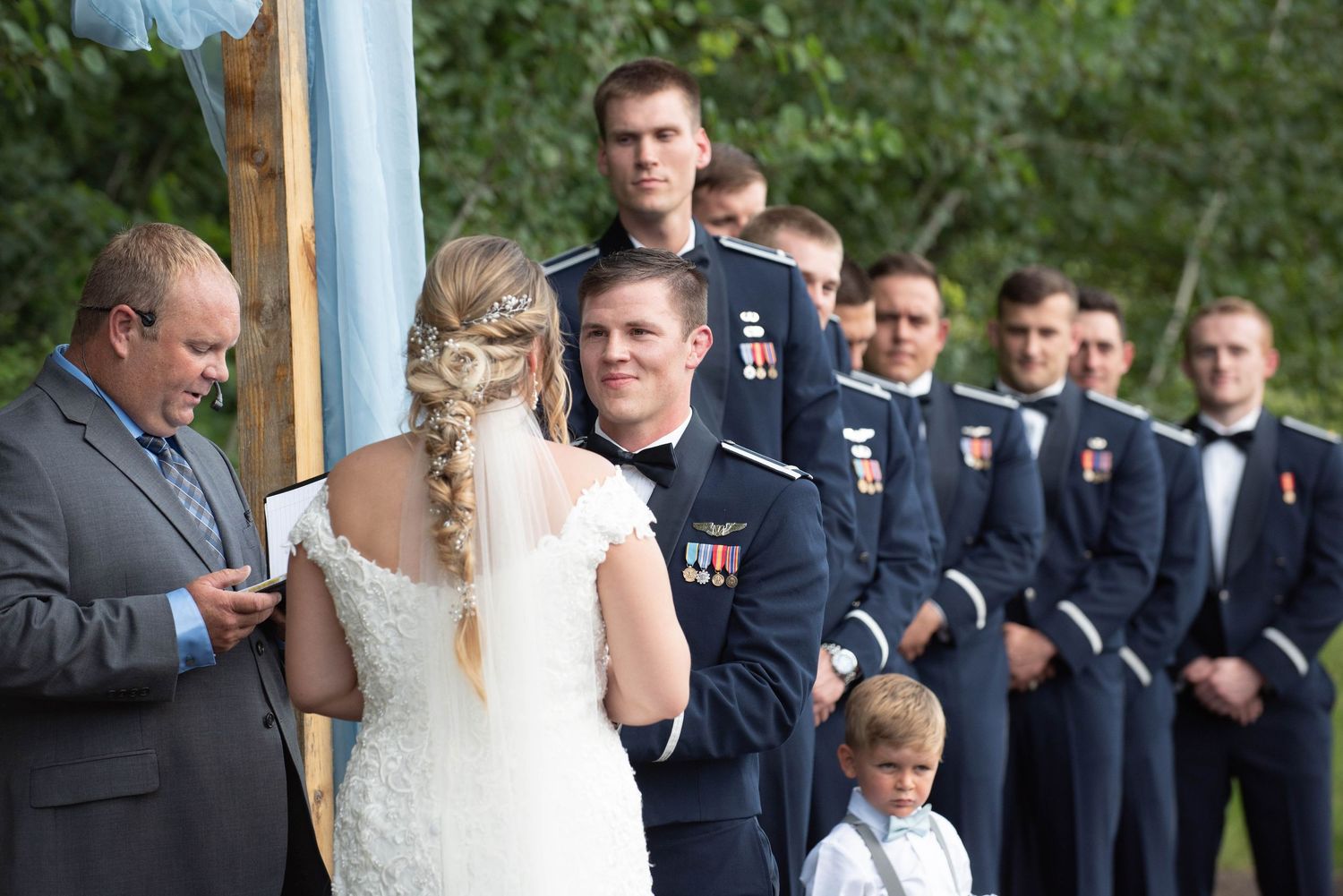 A wedding ceremony with uniformed service members standing in formation as part of the wedding party. Zimmerman MN Weddings