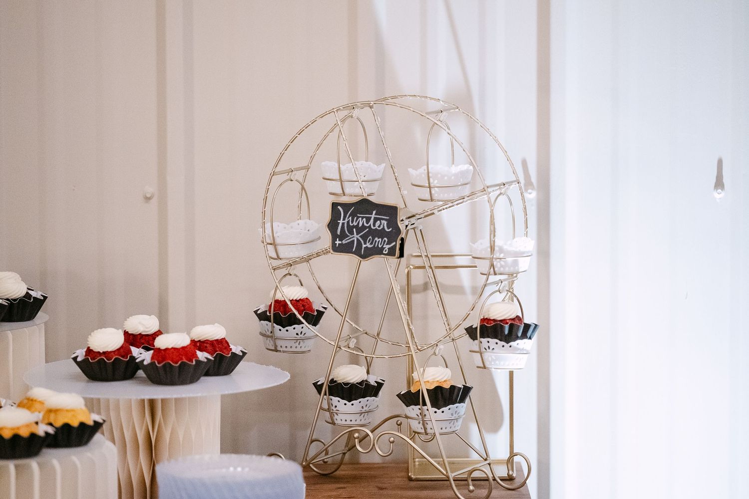 White decorative birdcage dessert displays arranged on a clean white table setting.