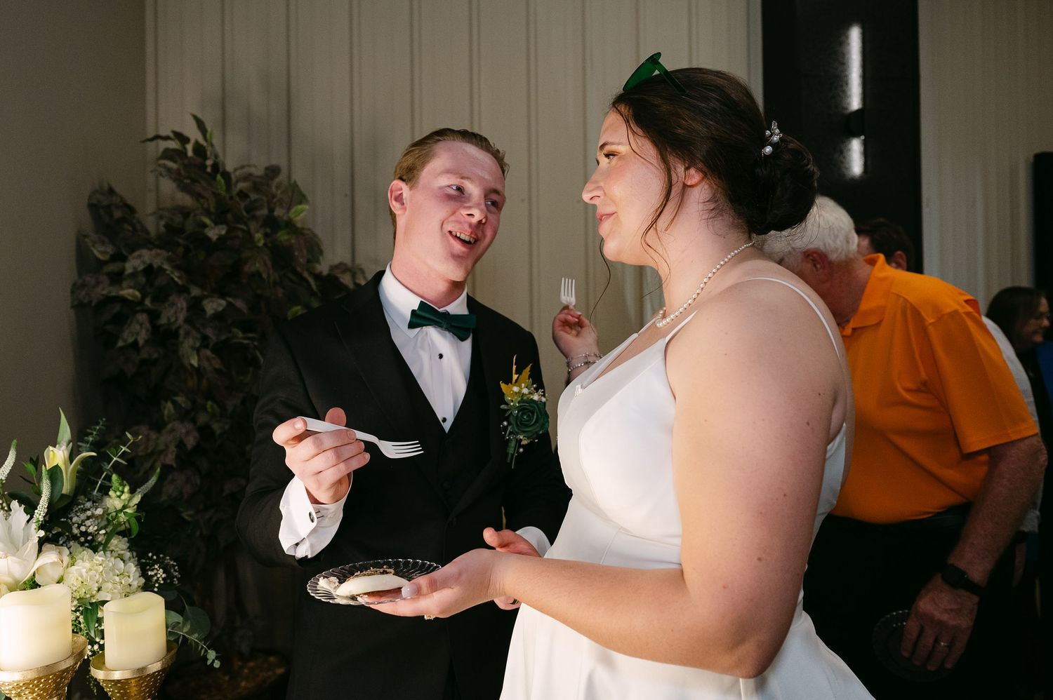 A wedding reception celebration with guests dancing and enjoying festivities in an elegant indoor venue.