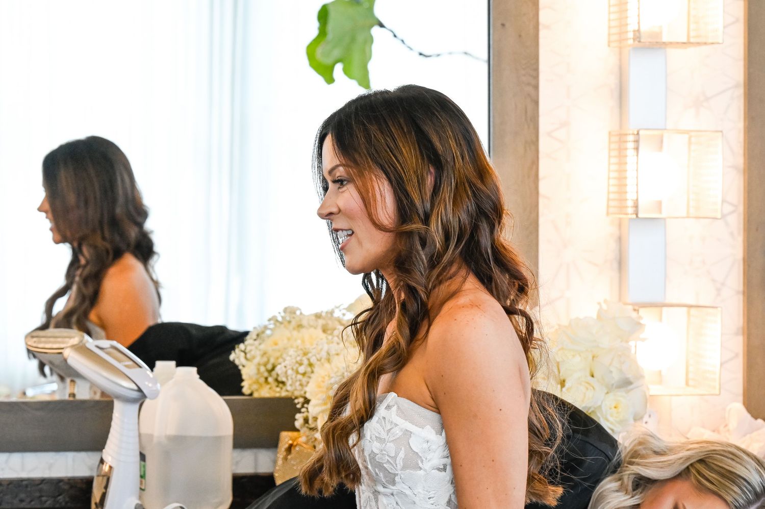 Wedding preparations showing attendants helping with final touches.