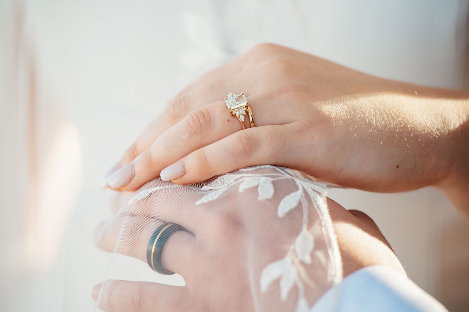 Detailed shots of wedding rings and jewelry against a light background.