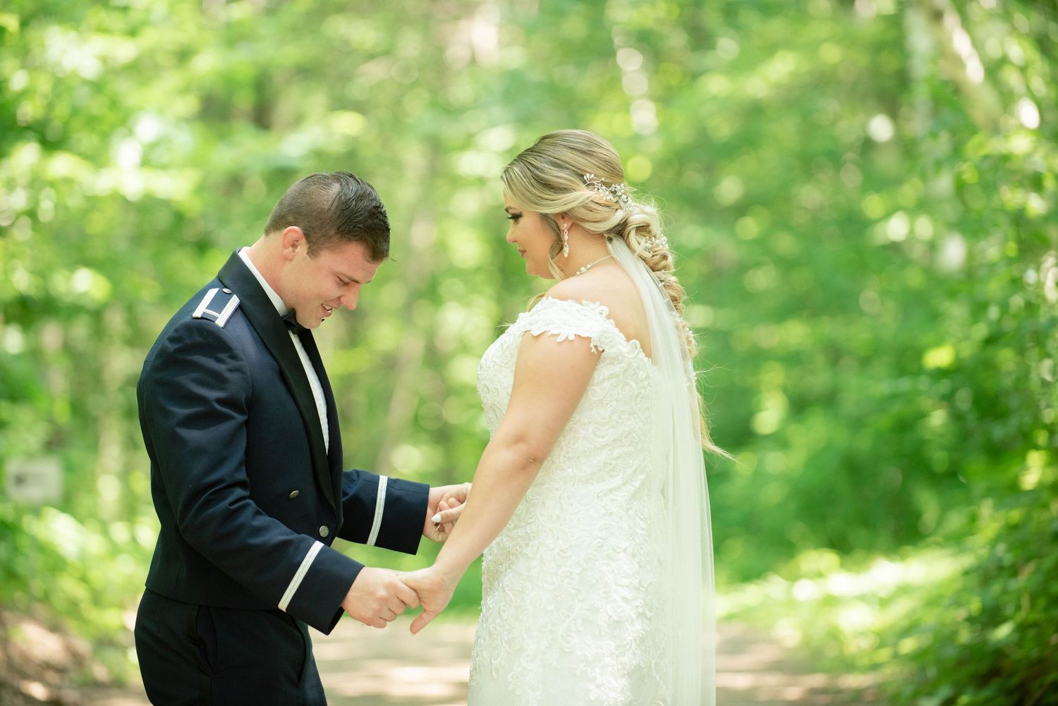 Couple shares an intimate moment during their outdoor forest wedding ceremony. Zimmerman MN Weddings