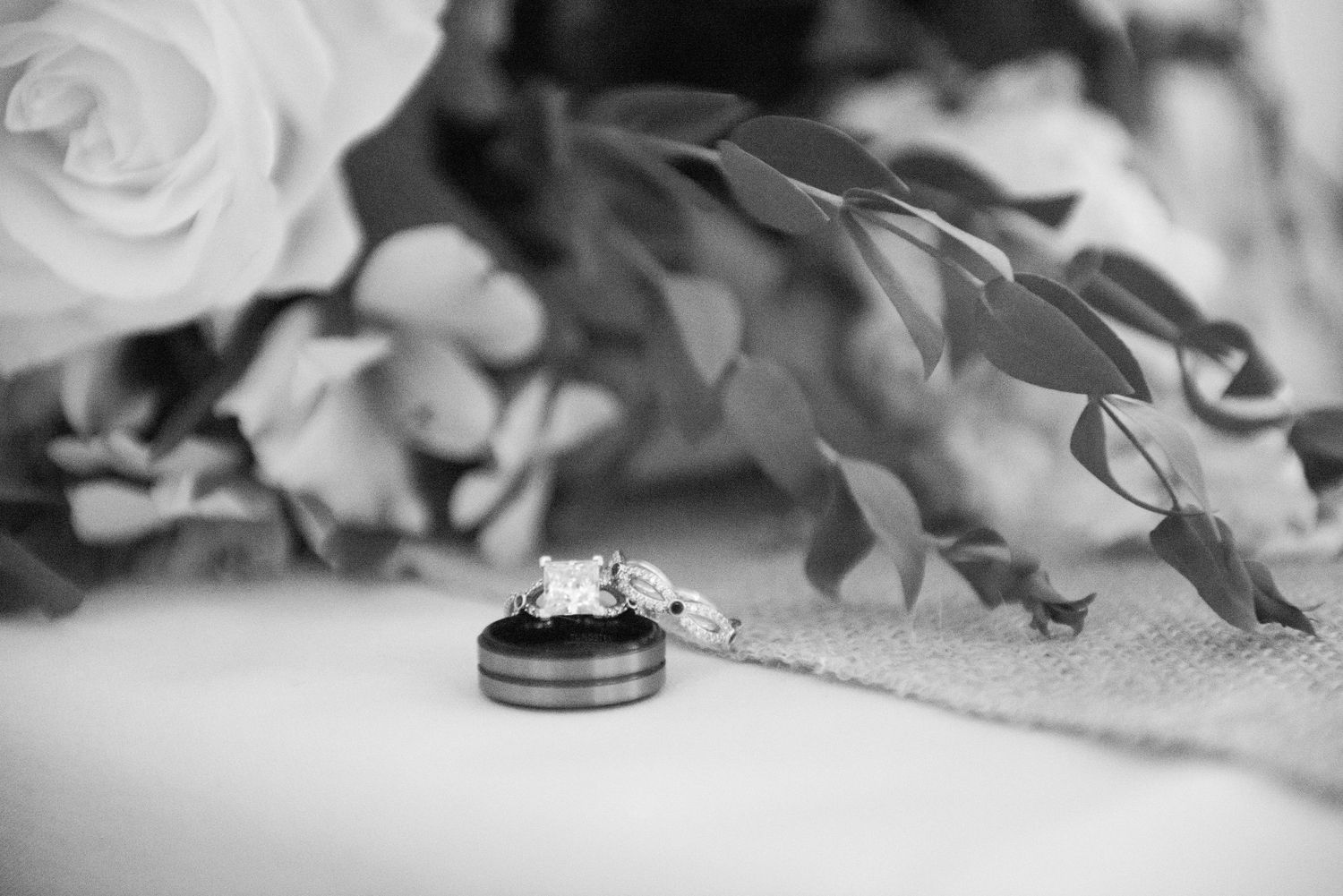Artistic black and white detail shots of wedding rings and flowers. Zimmerman MN Weddings