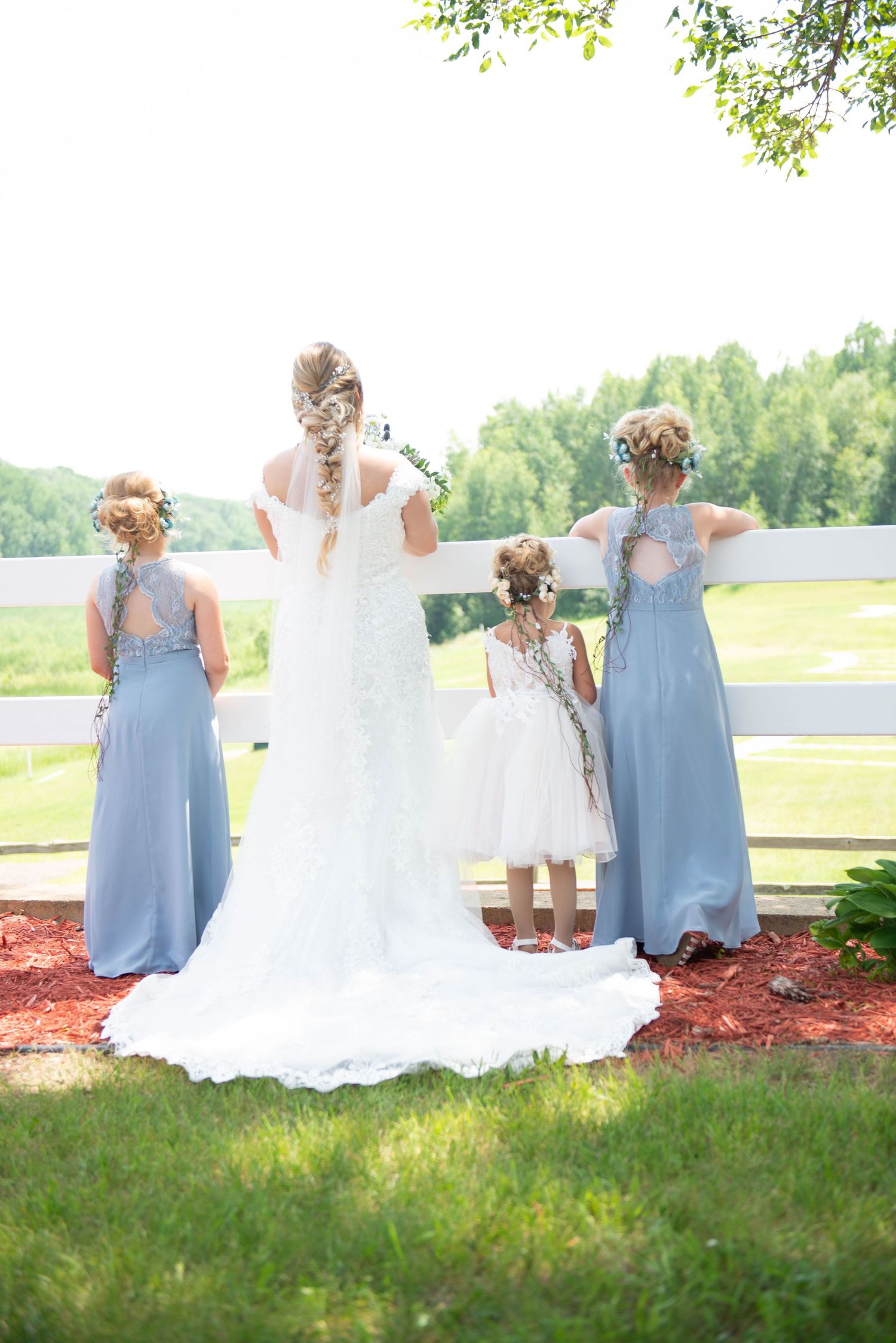 Wedding party in light blue dresses standing at a scenic overlook. Zimmerman MN Weddings