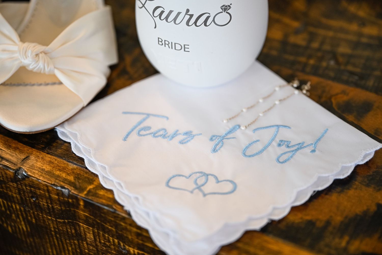 Handwritten wedding notes and keepsakes displayed on a rustic wooden surface.