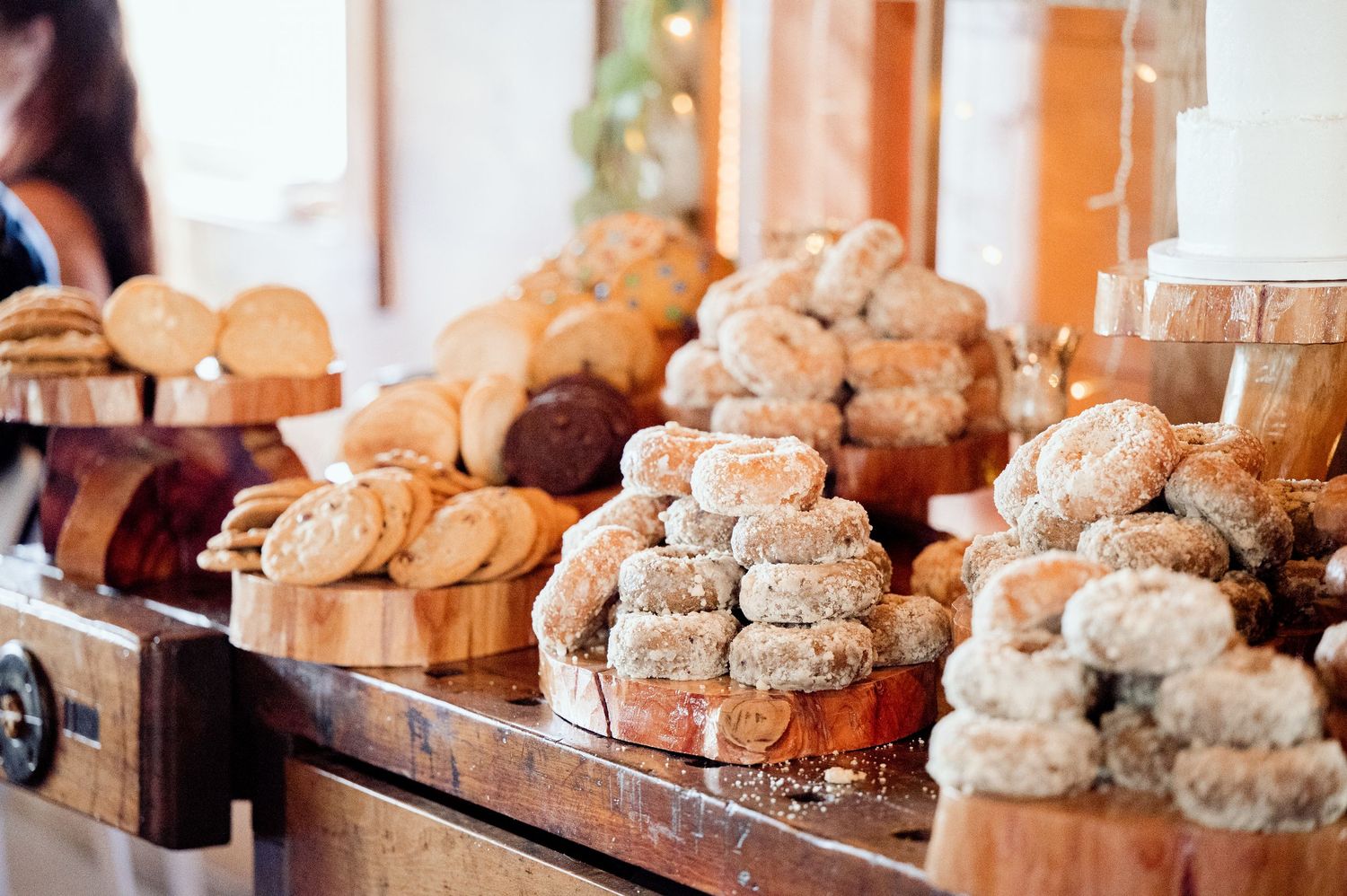 Artfully arranged display of assorted homemade dinner rolls and breads on a wooden surface.