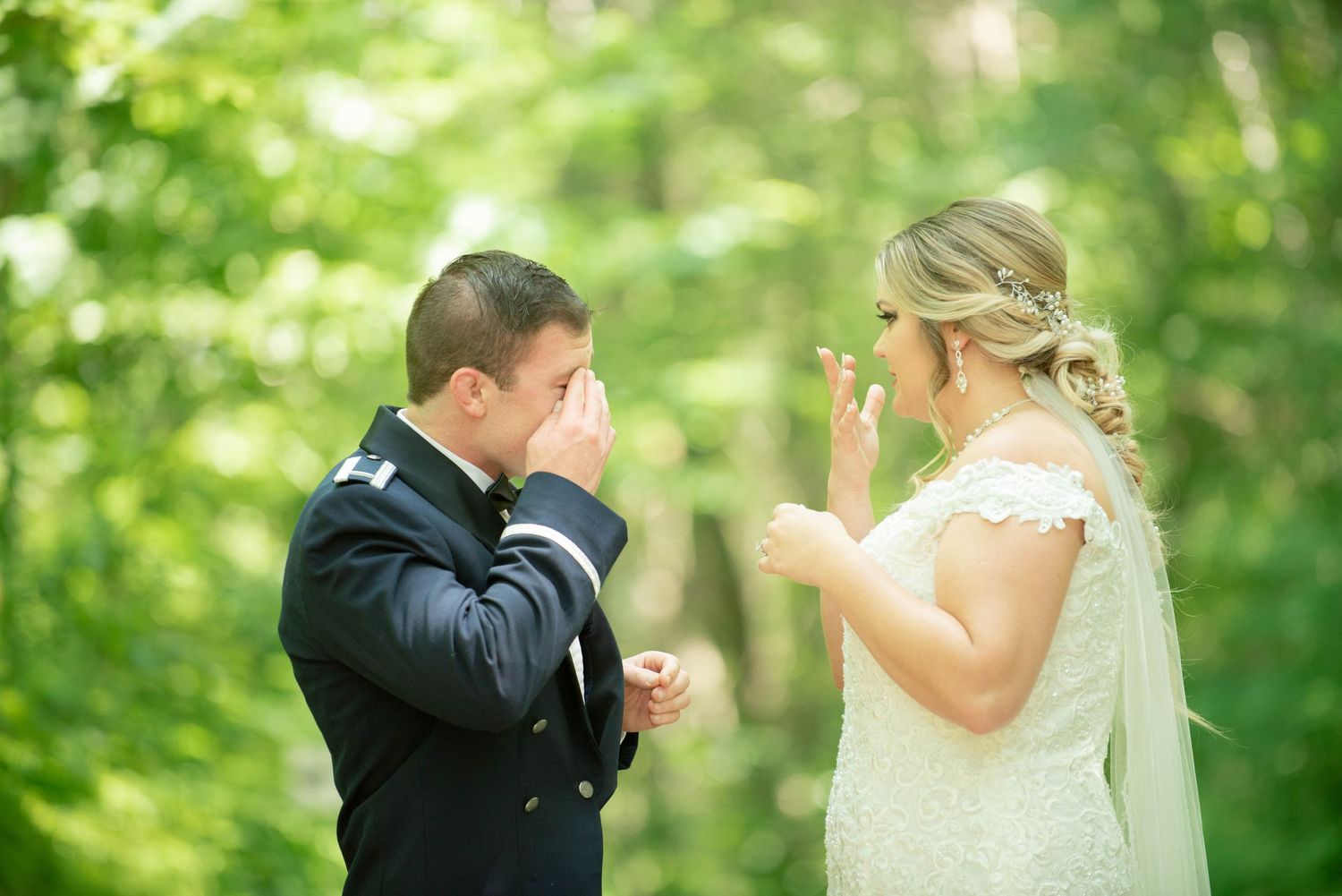 Emotional first look moment between wedding couple in a lush green outdoor setting. Zimmerman MN Weddings
