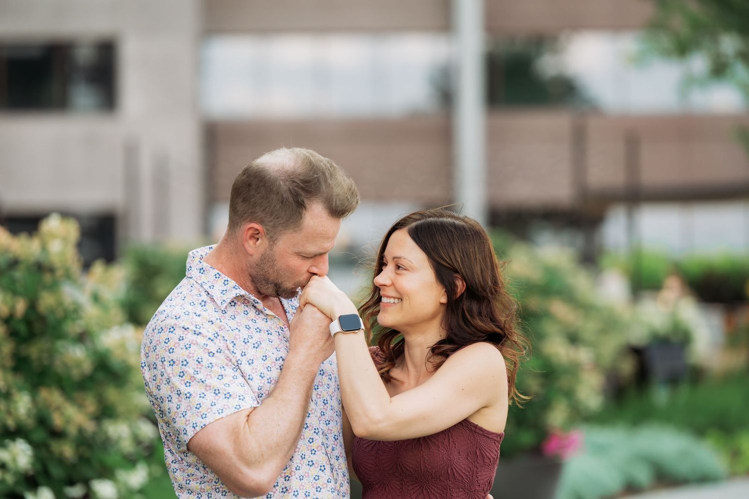 A couple shares tender moments in a romantic outdoor engagement photo session.