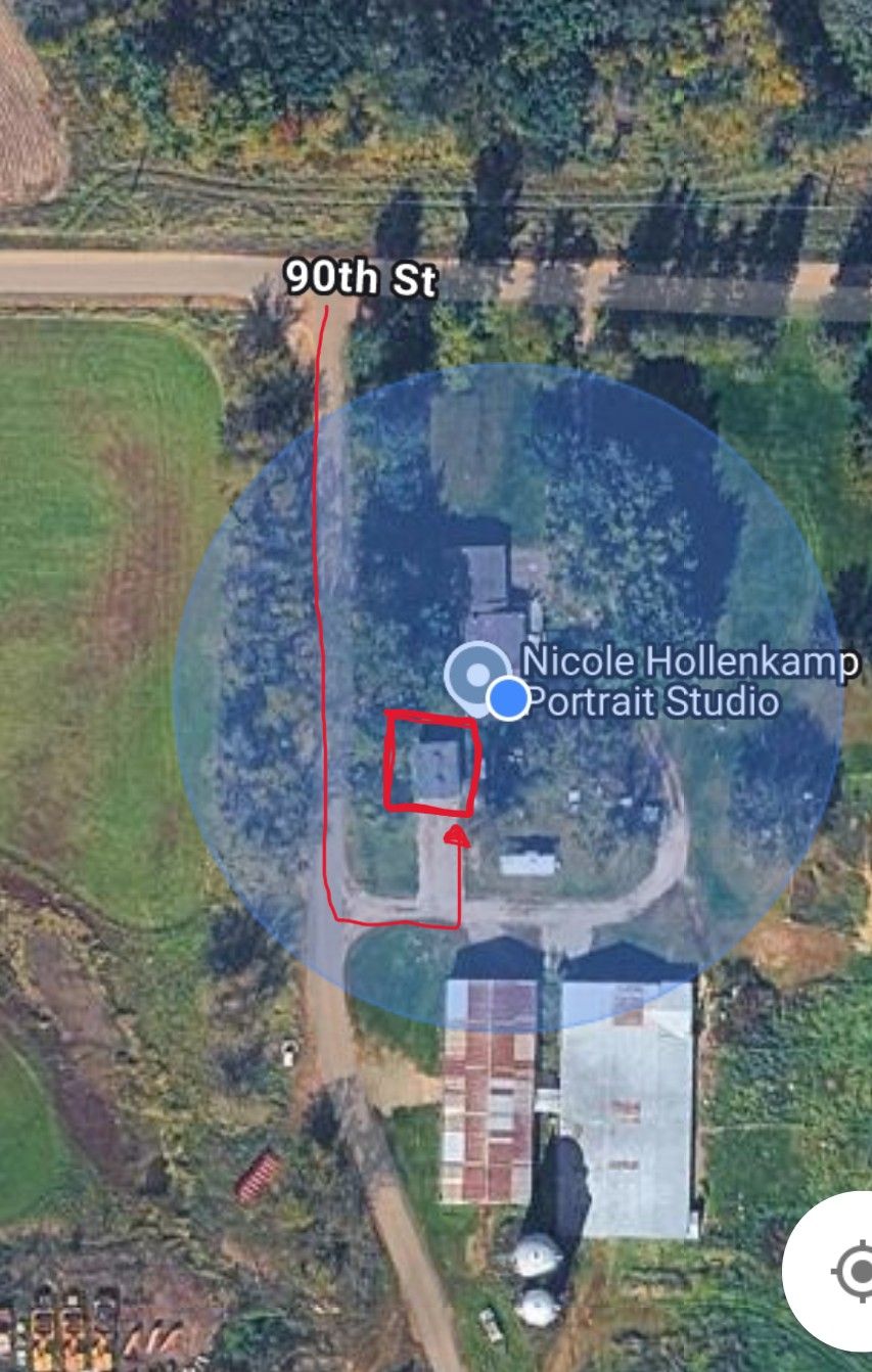 Aerial satellite view of a portrait studio property with driveway and surrounding trees on 90th Street.
