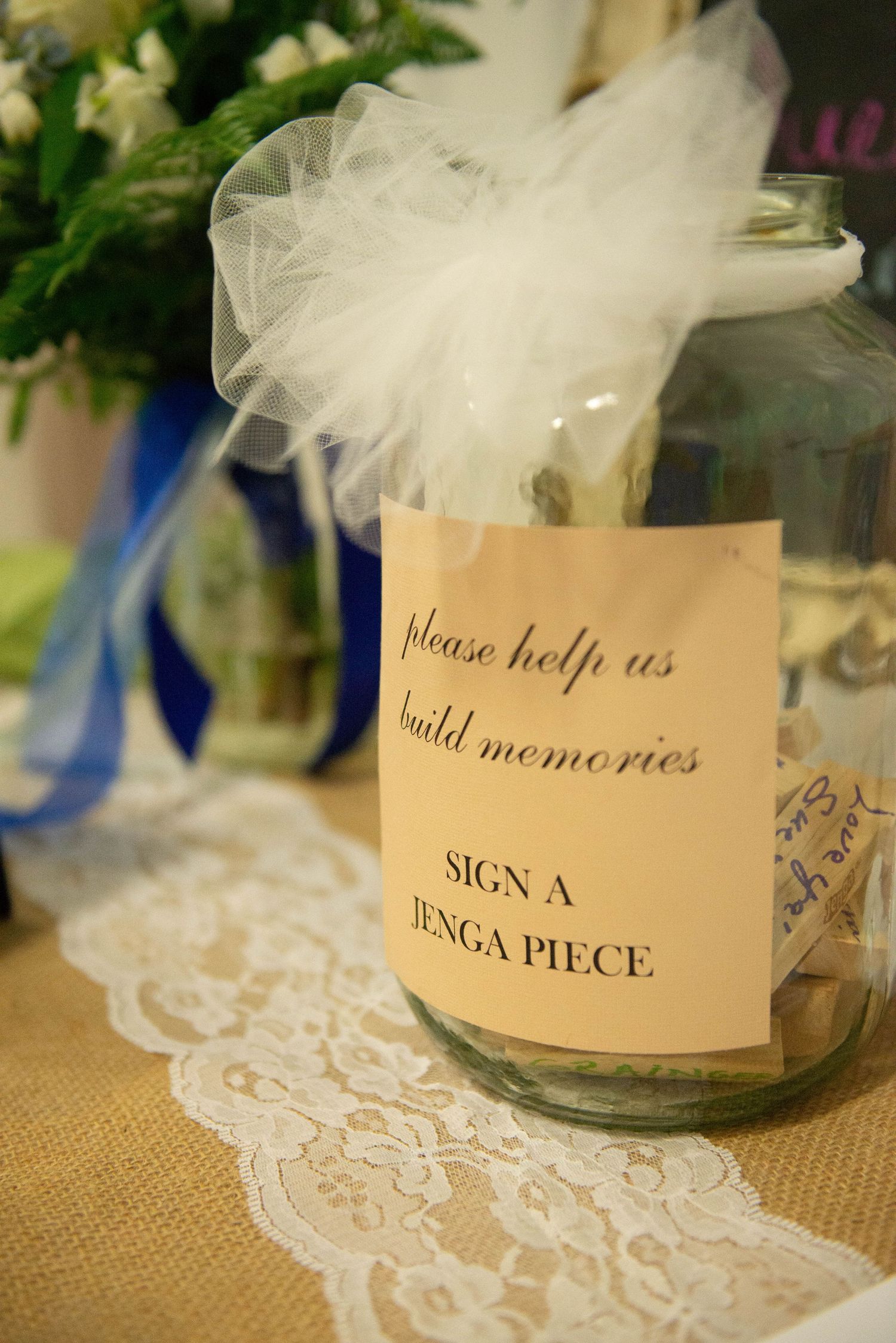 Wedding guest book station with lace doilies and handwritten signs in mason jars for memories. Zimmerman MN Weddings