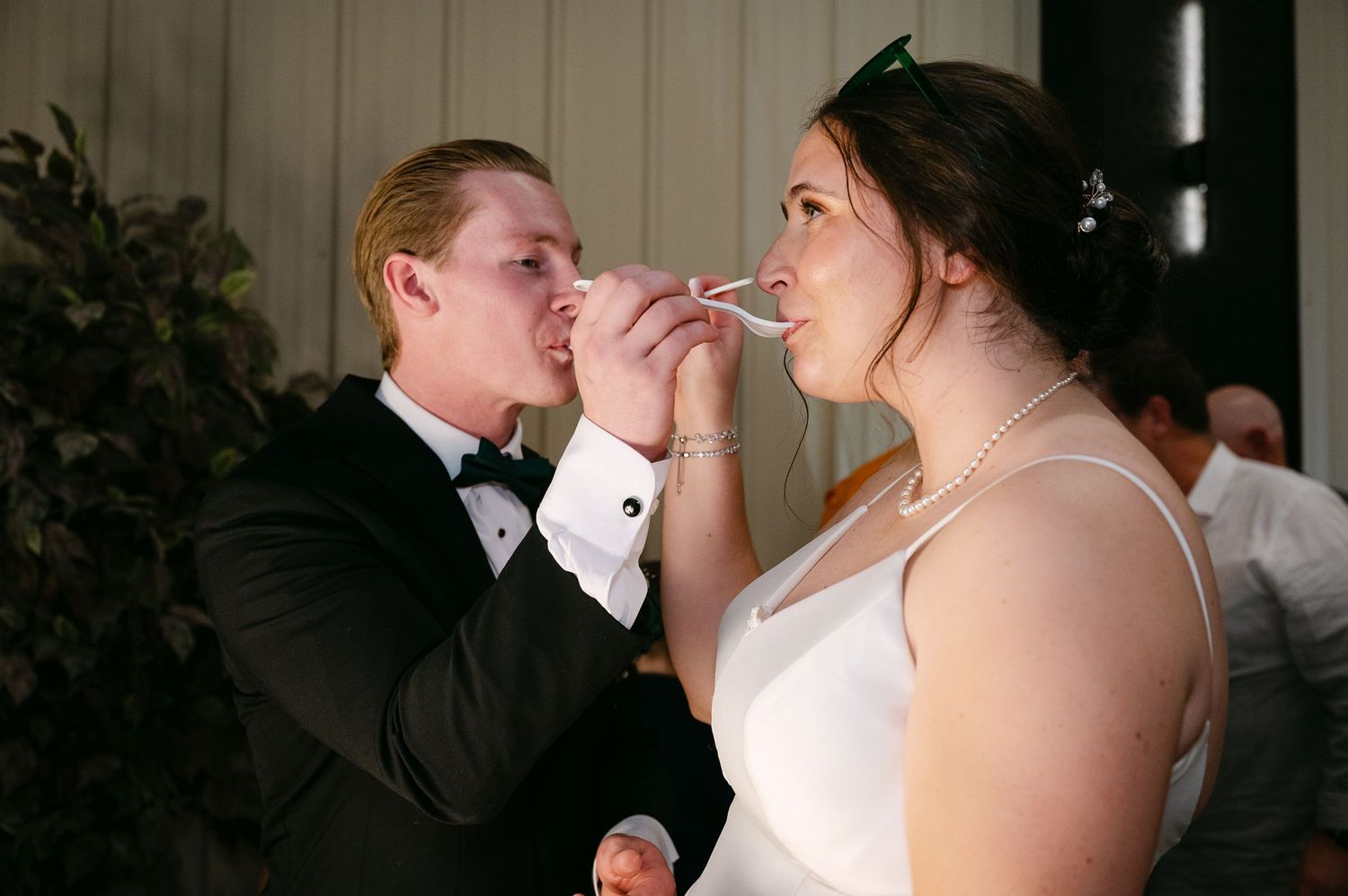A couple shares a romantic dance together at their wedding reception, with multiple candid moments captured in sequence.