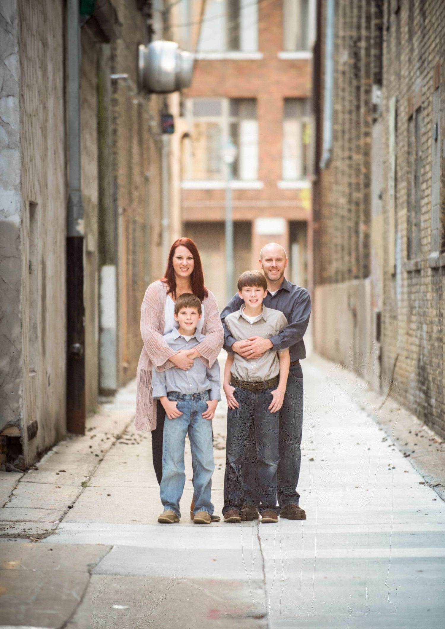 Family walking together down a narrow urban alley with brick walls on both sides.
