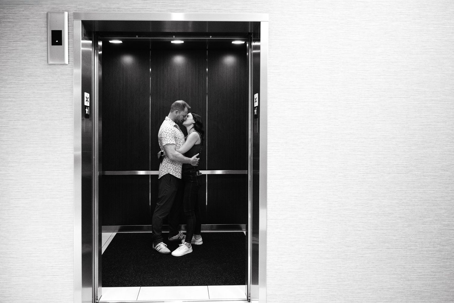 Black and white photos of romantic moments captured in an elevator sequence.