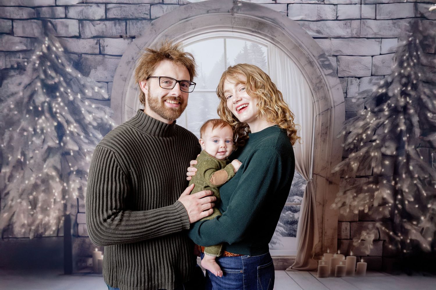 A family of three poses together for a winter holiday portrait against a stone archway and snowy backdrop. Princeton MN Milestone, Maternity
